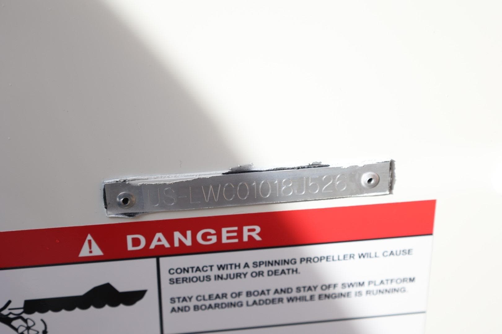 2026 Lowe Fishing Machine 1675 WT warning label and serial number plate.