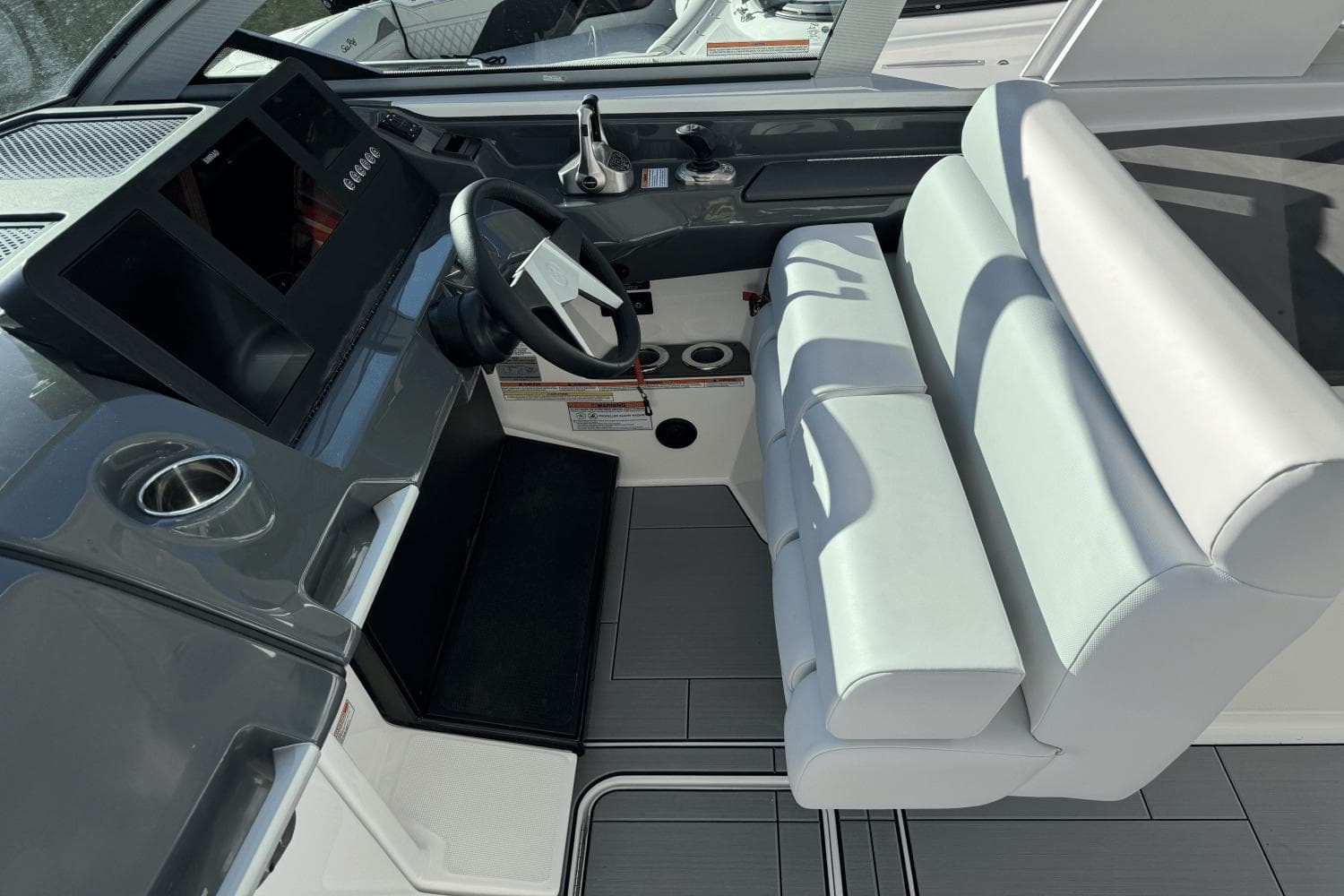 2024 Aviara AV32 boat cockpit with modern steering and seating.