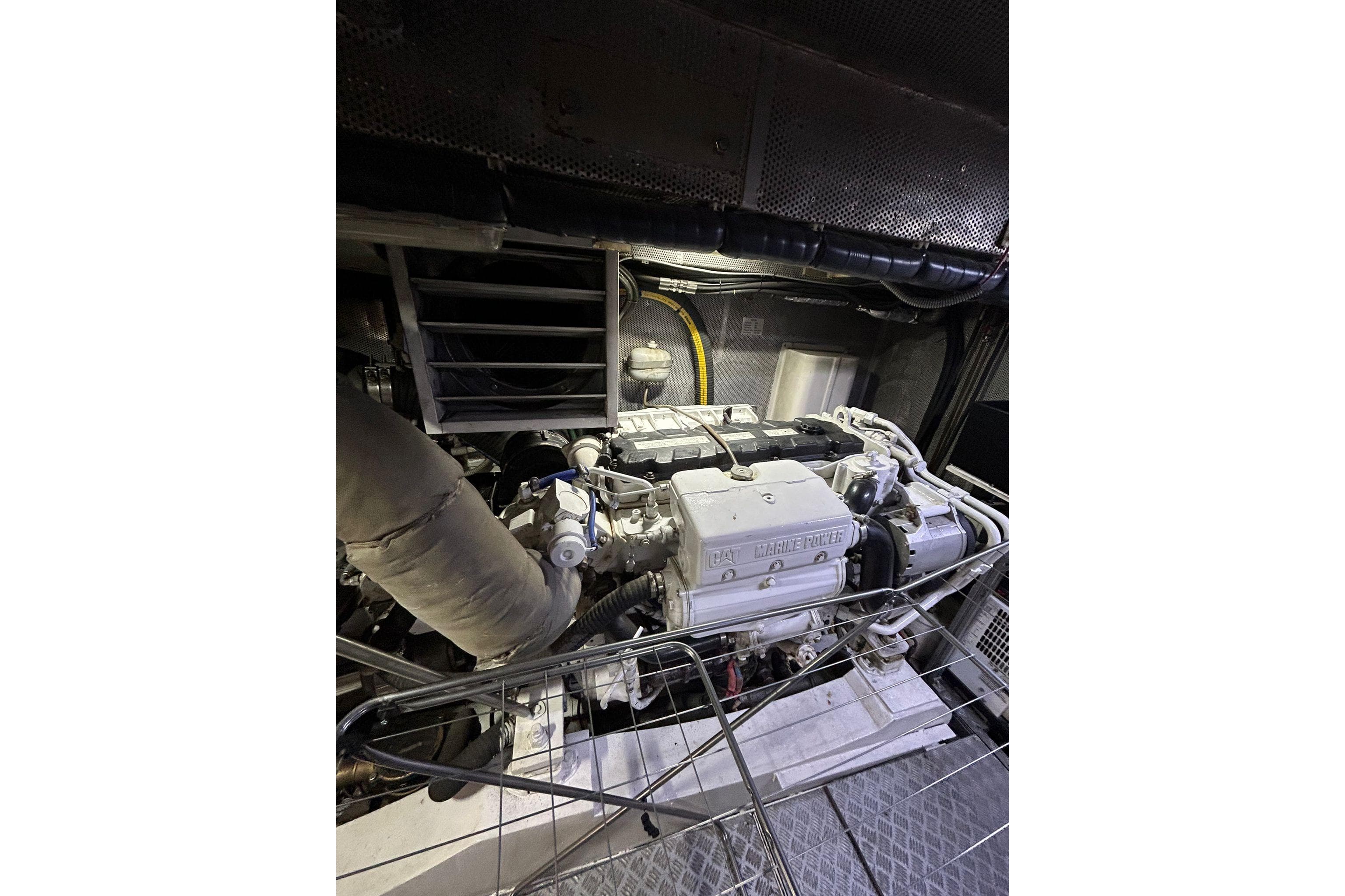 Engine room of a 2009 Custom 68 model, featuring a CAT marine power engine.