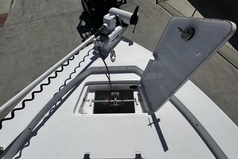 2024 SPORTMAN MASTERS 227 boat deck with open hatch and trolling motor.