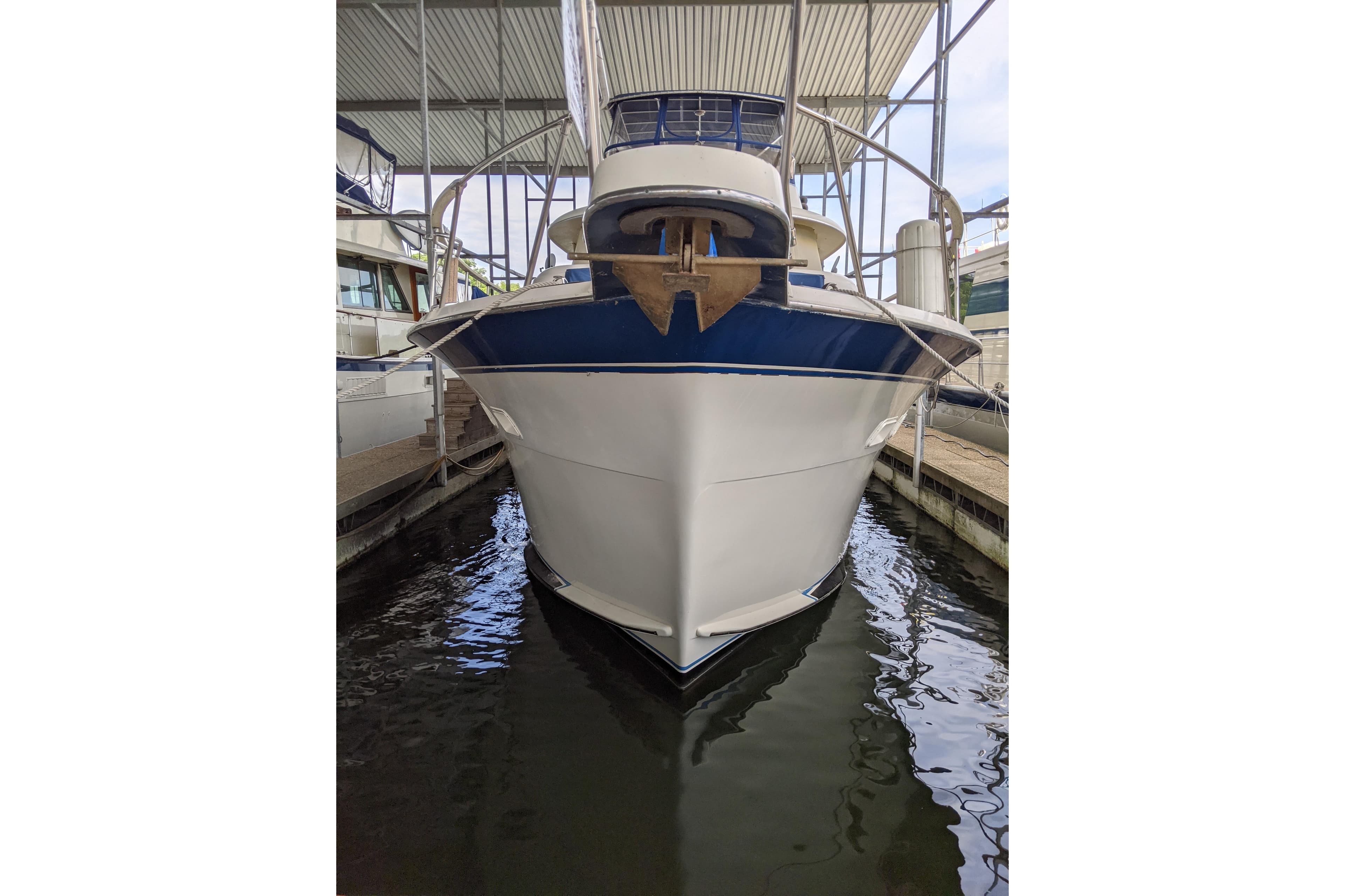 1984 Hatteras 53 Extended Deckhouse Motor Yacht docked in a marina.