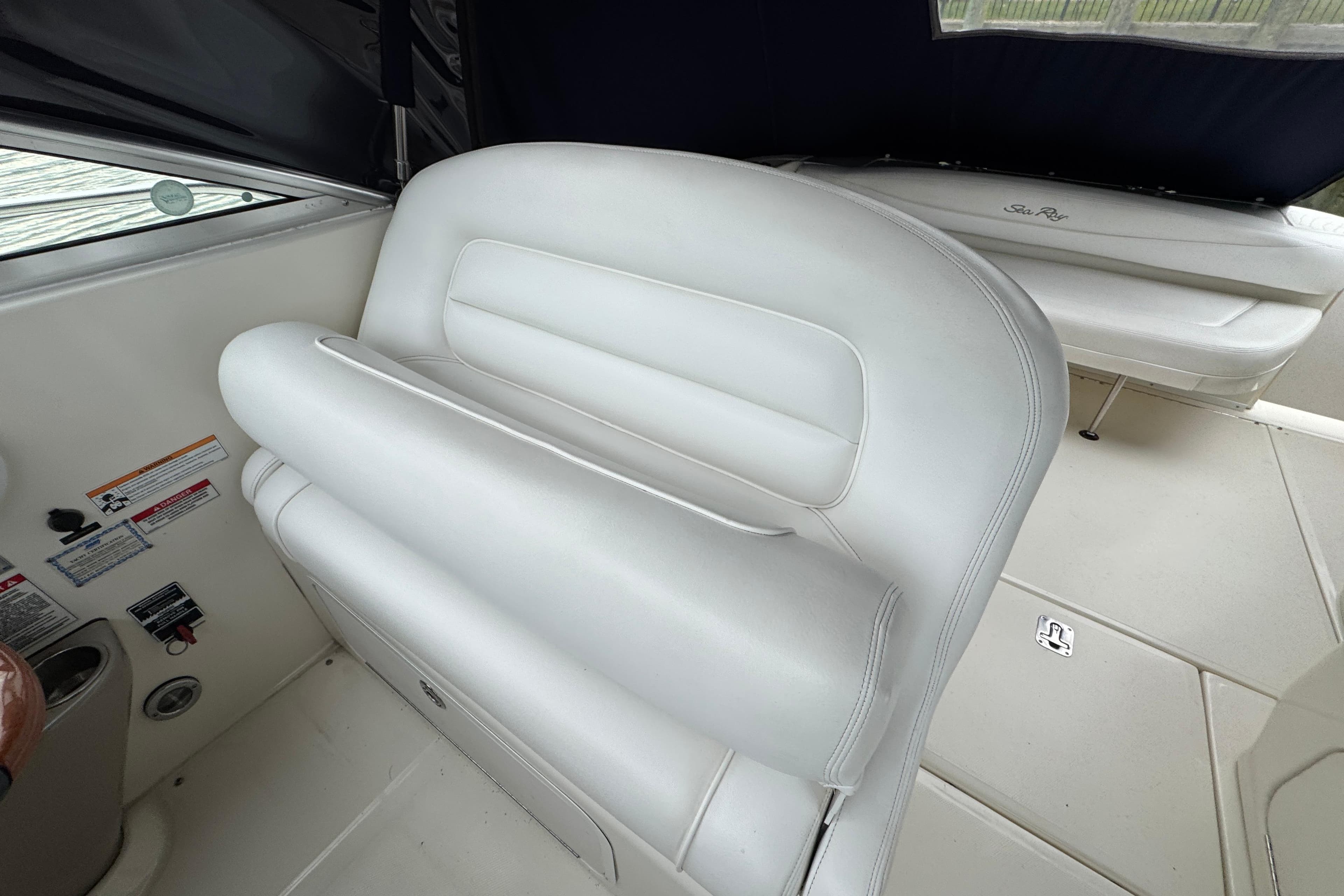 2007 Sea Ray 290 Amberjack interior with white seating and control panel.