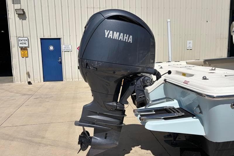 2024 Key West 210 Bay Reef boat with Yamaha outboard motor in a marina setting.