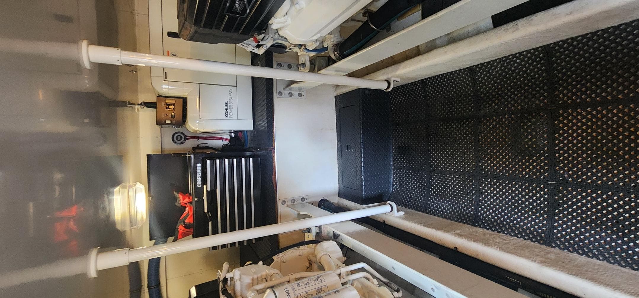 Engine room of a 2004 Silverton 48 Convertible yacht, featuring equipment and storage.