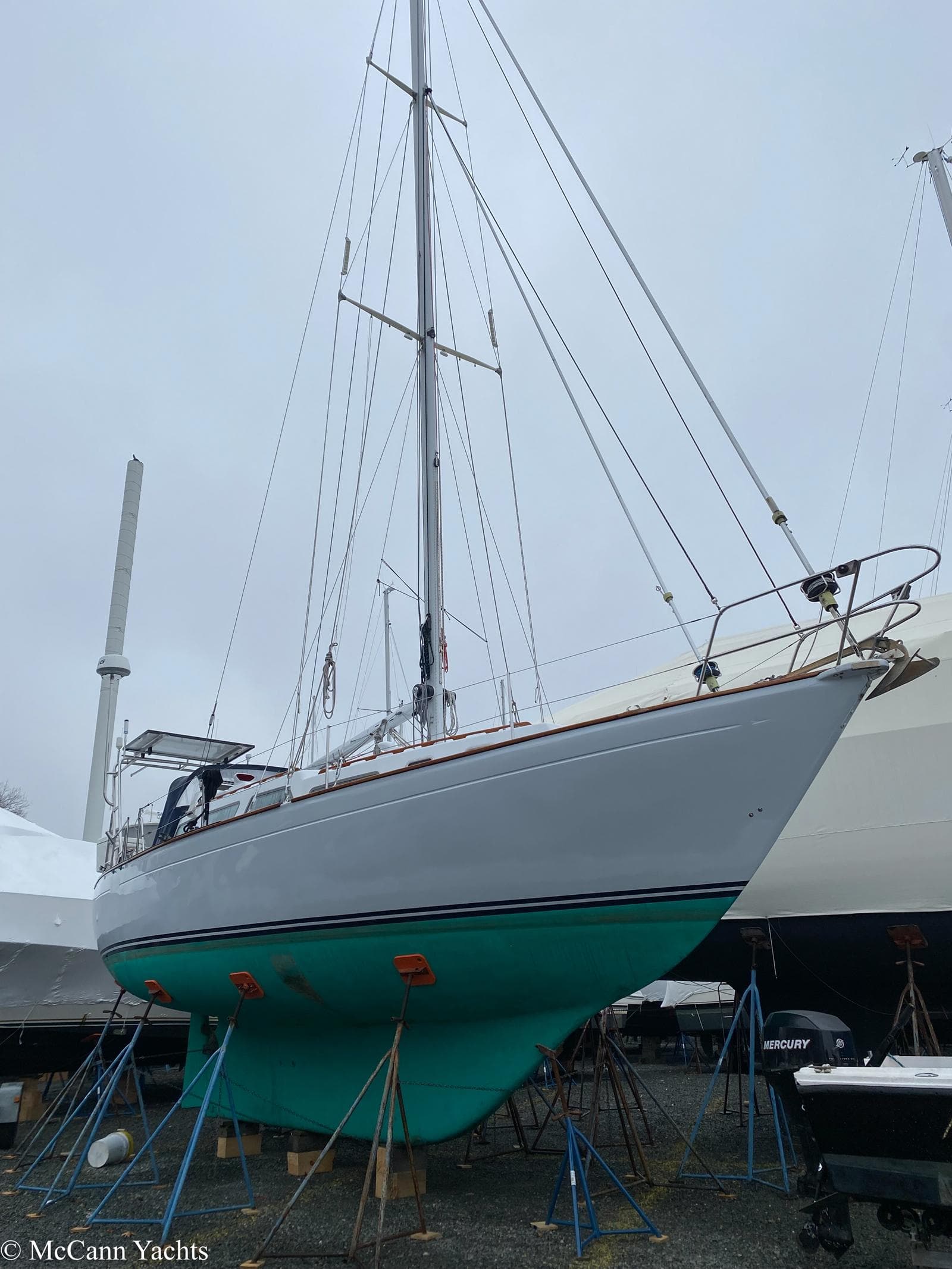 1973 Challenger 40 sailboat on stands, showcasing sleek design and turquoise hull.