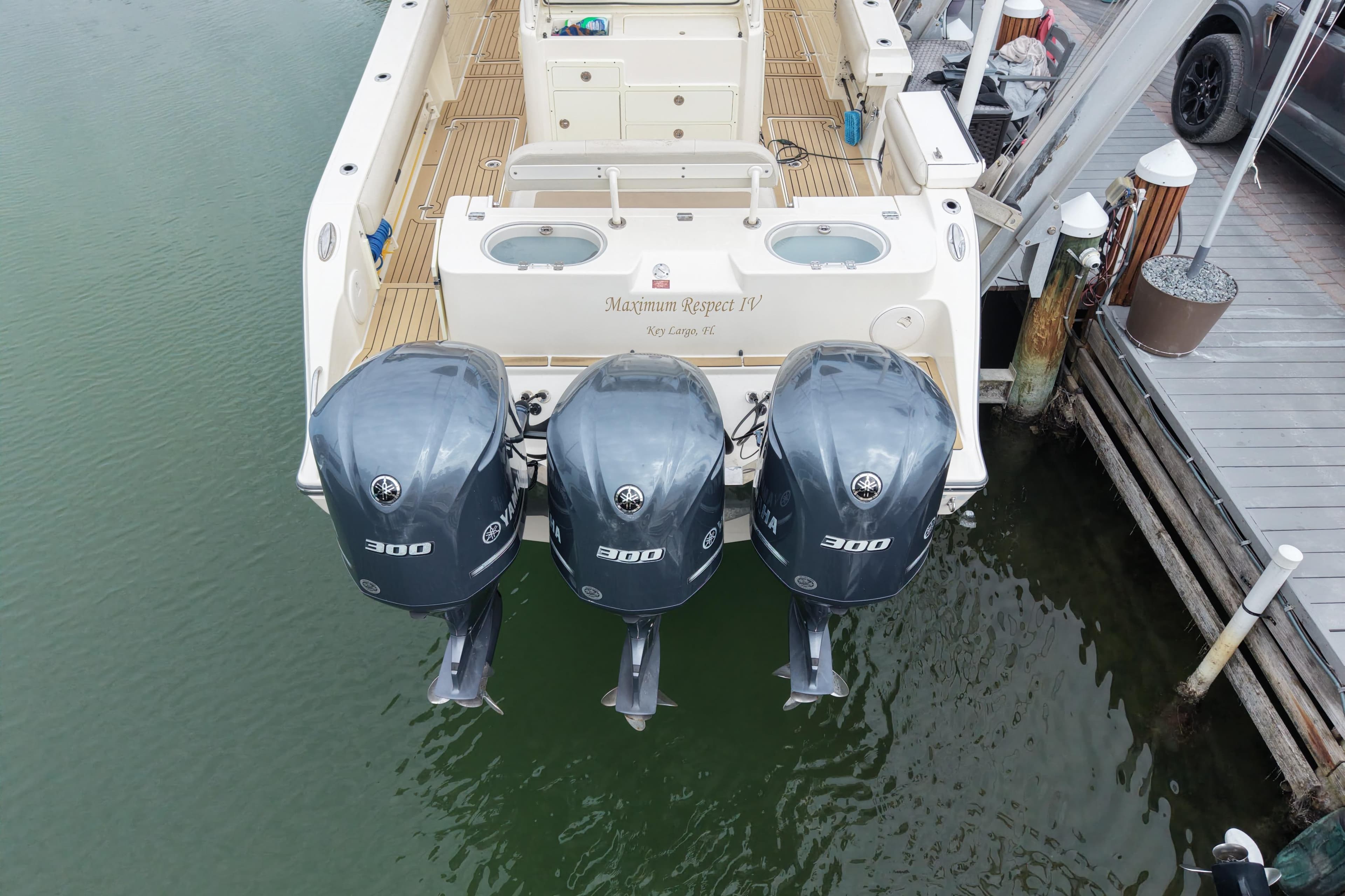 2015 Cobia 344 Center Console with triple Yamaha 300 engines docked.