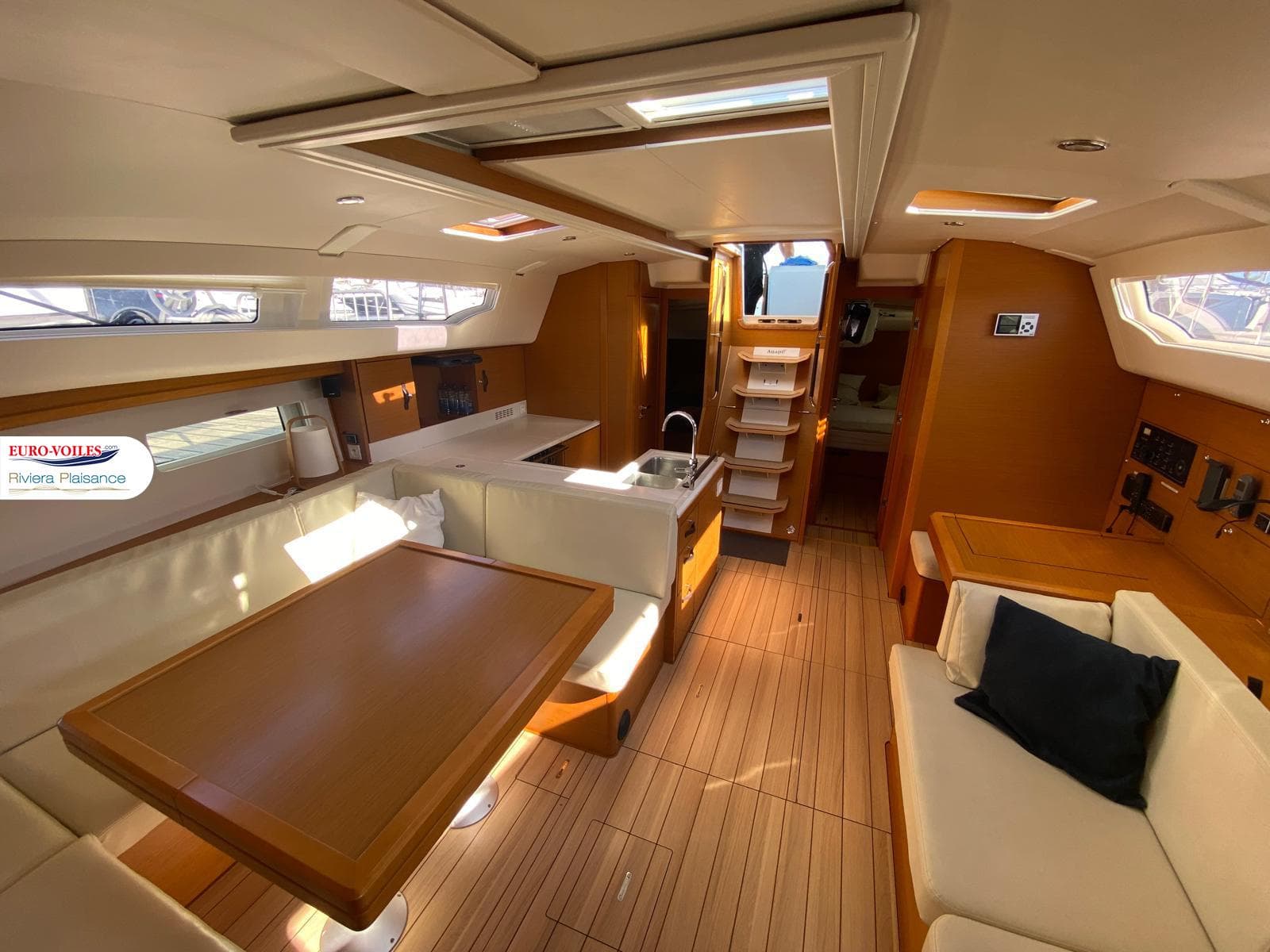 Luxurious interior of a 2017 Jeanneau 51 yacht with modern furnishings and wood finish.