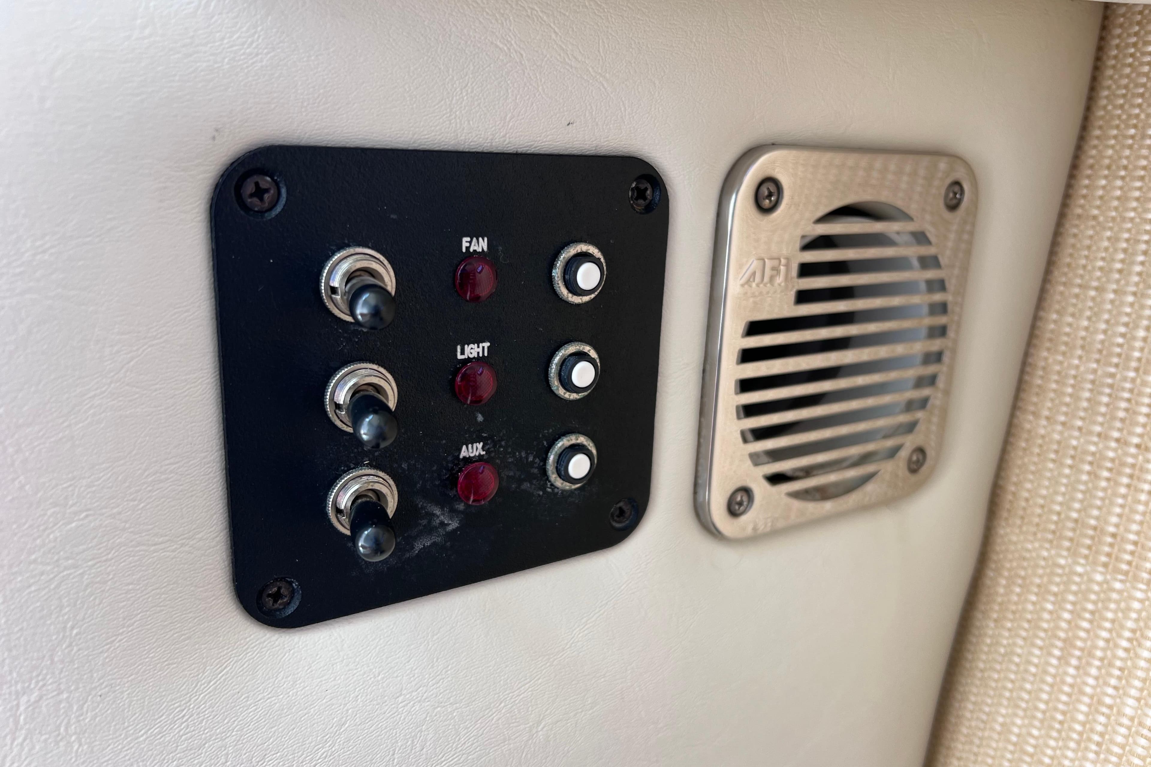 Control panel and speaker on a 2015 Cobalt 26SD boat interior.
