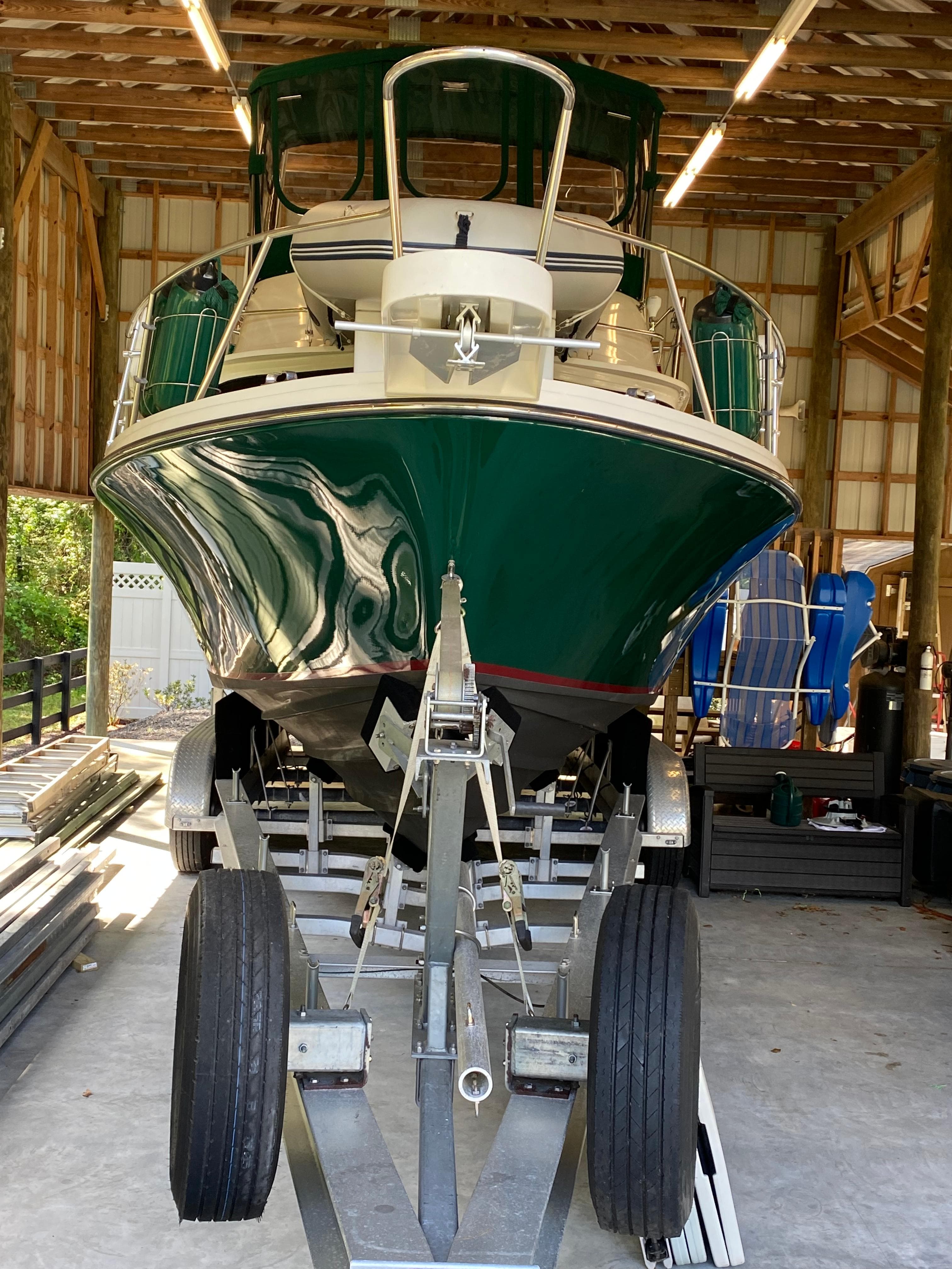 1988 Blackfin 29 Flybridge boat on trailer in covered storage.