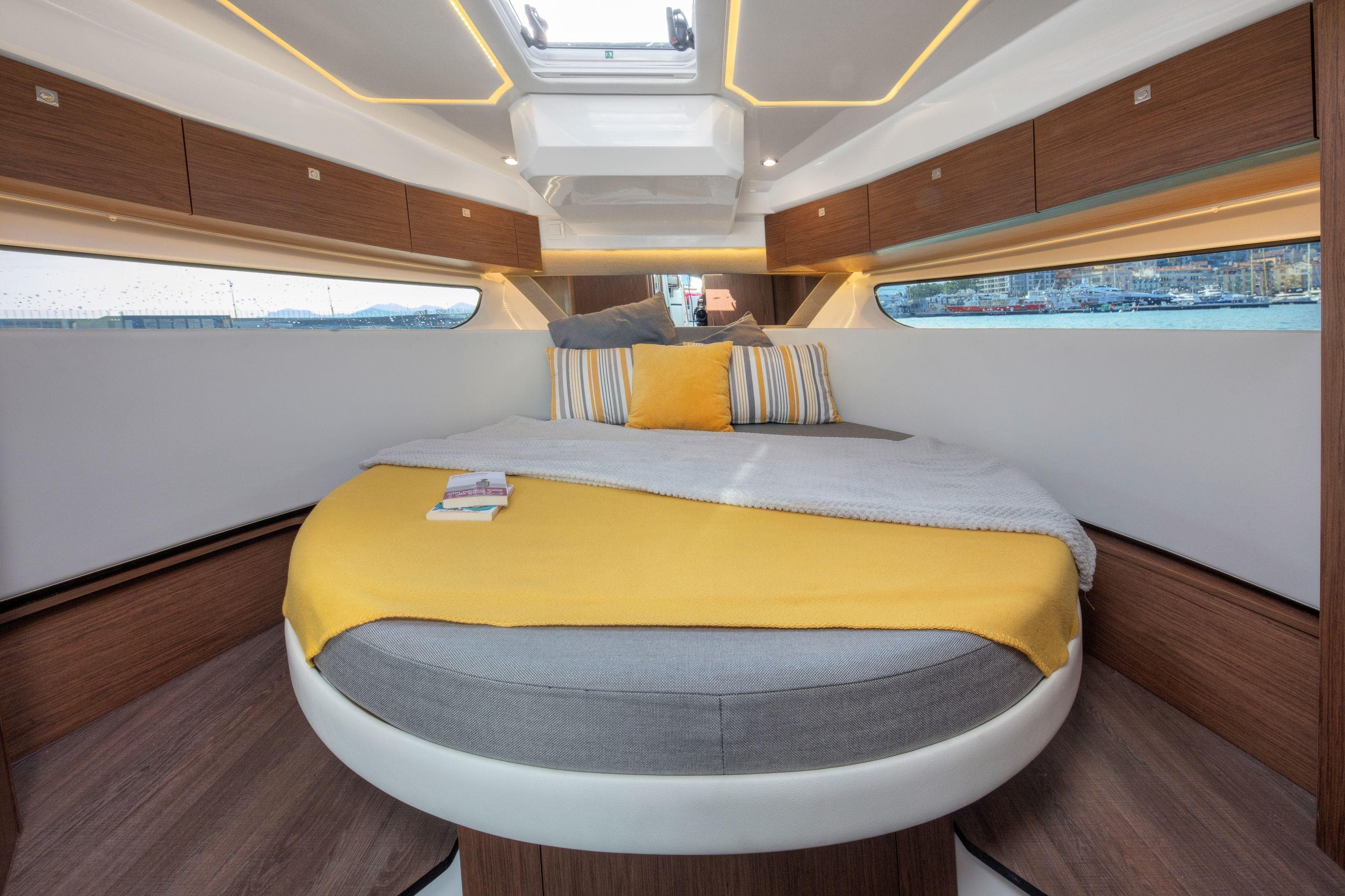 Luxurious cabin interior of 2025 Jeanneau NC 1095 Fly with cozy bed and modern design.