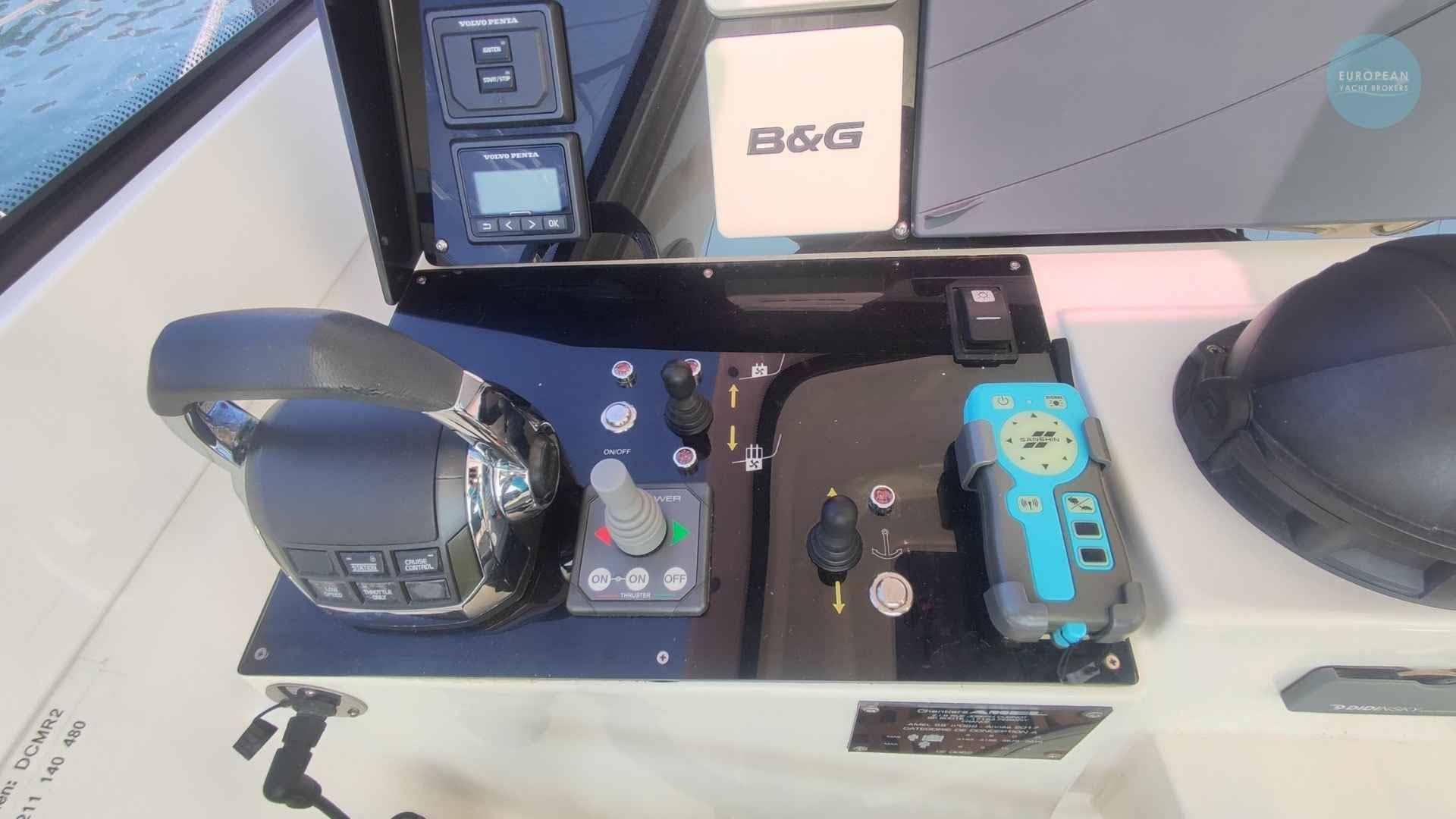 Control panel of a 2017 Amel 55 yacht with navigation and throttle controls.