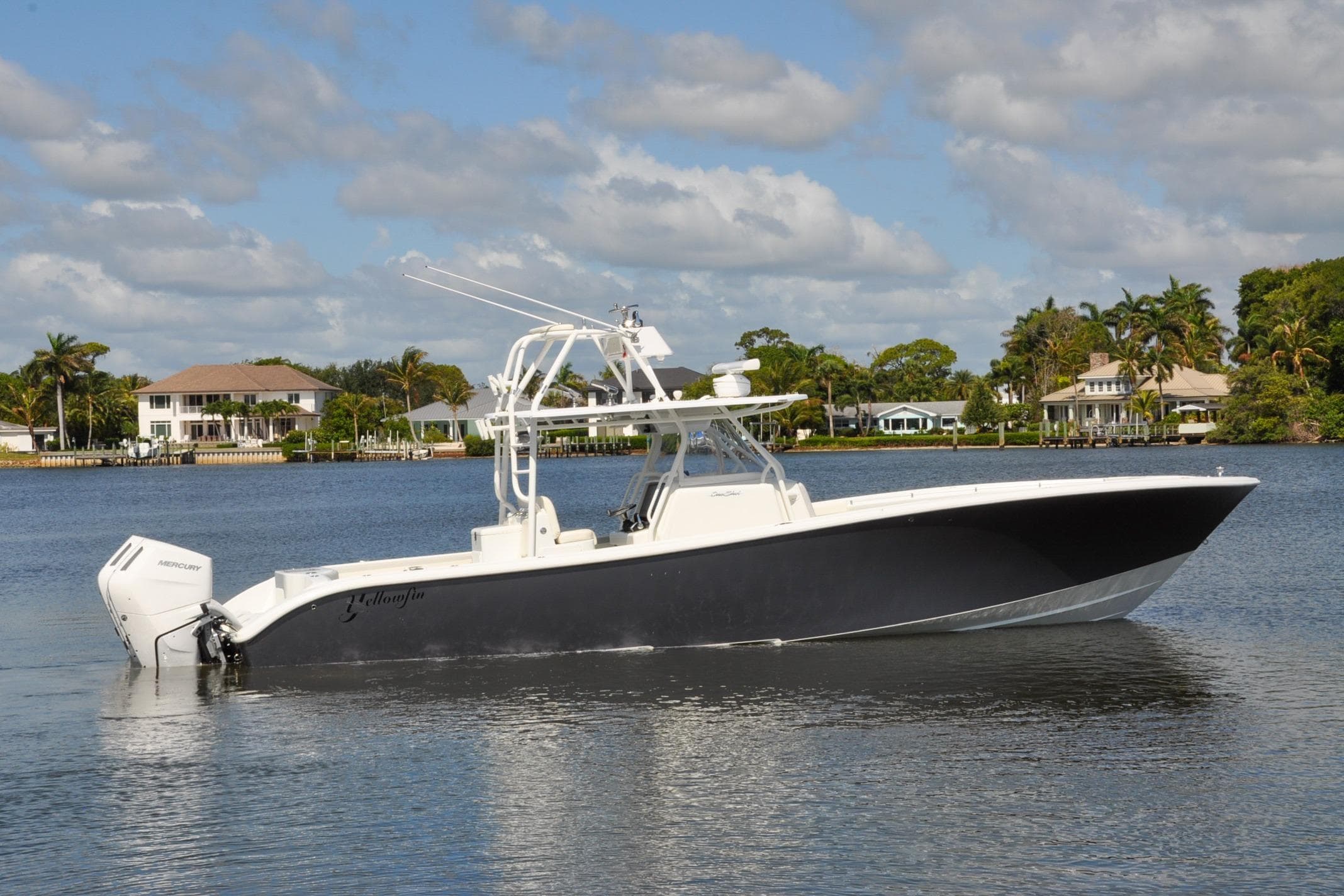 2011 Yellowfin 39 Offshore boat on calm water, with waterfront homes in the background.