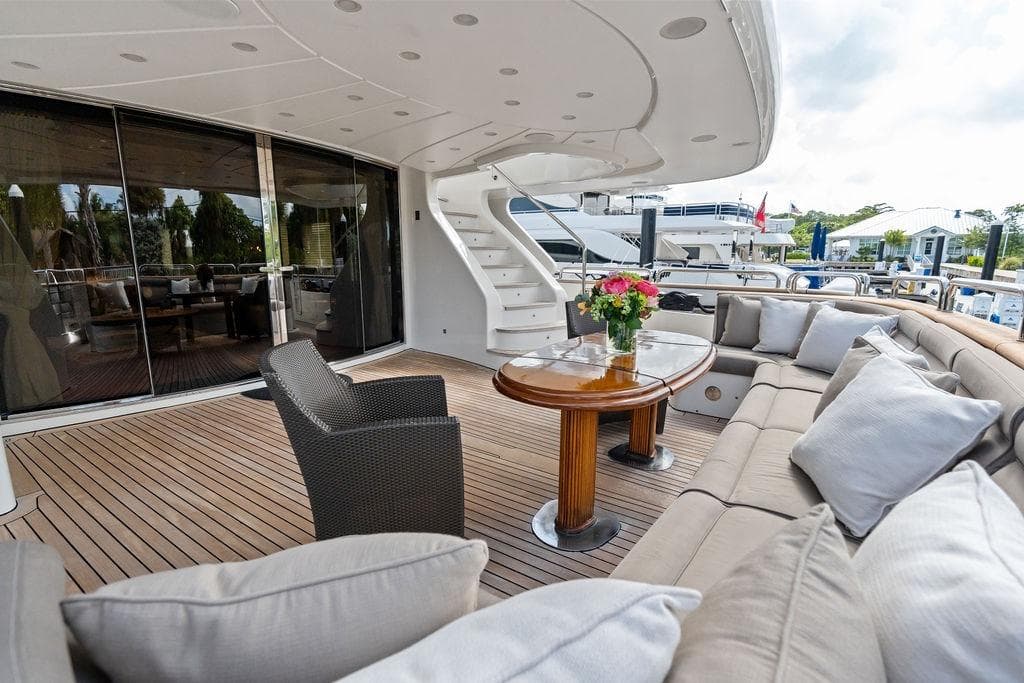 Luxurious 2008 Benetti Classic yacht deck with elegant seating and floral centerpiece.