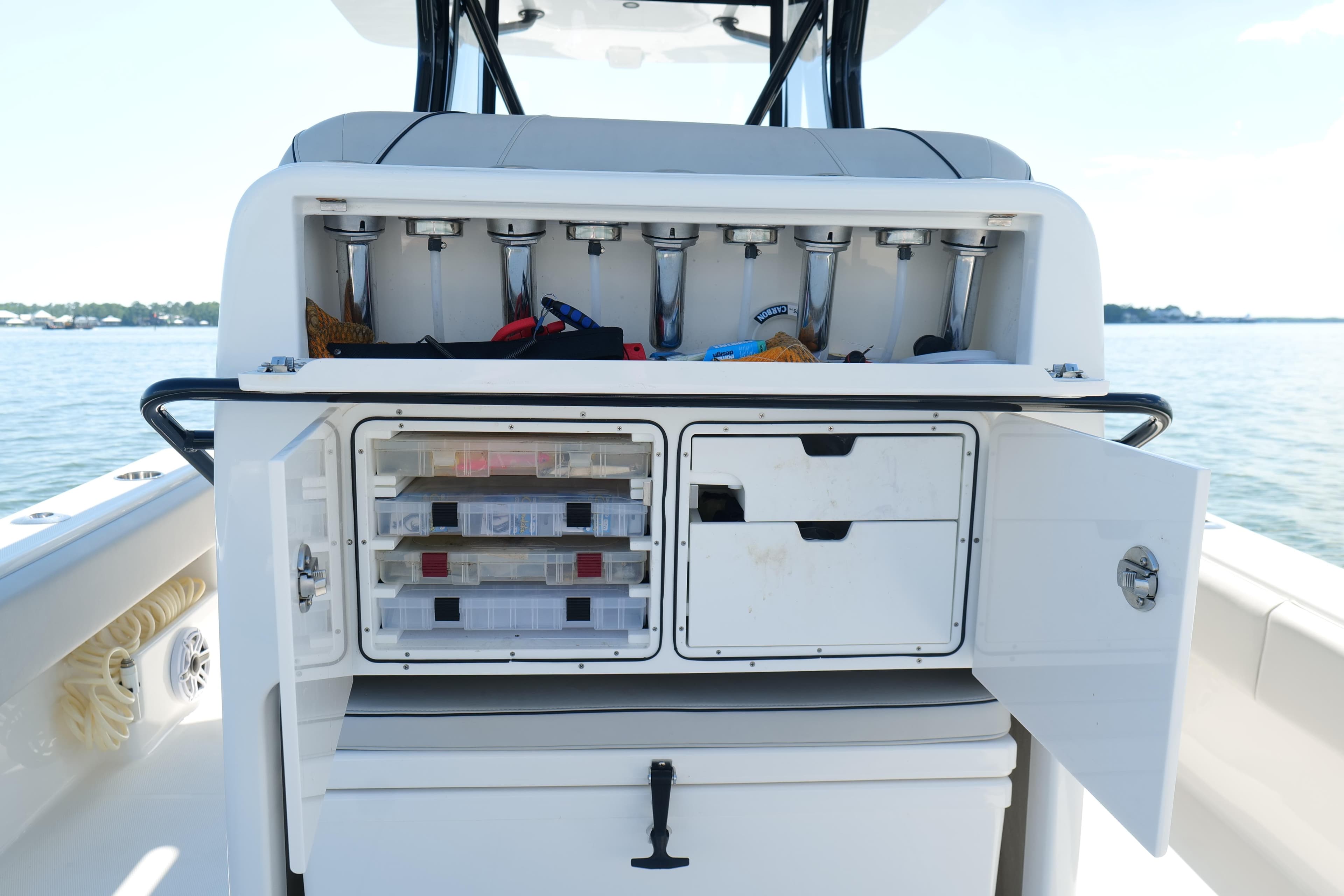 2023 SeaVee 32 boat with open storage compartments and fishing rod holders.