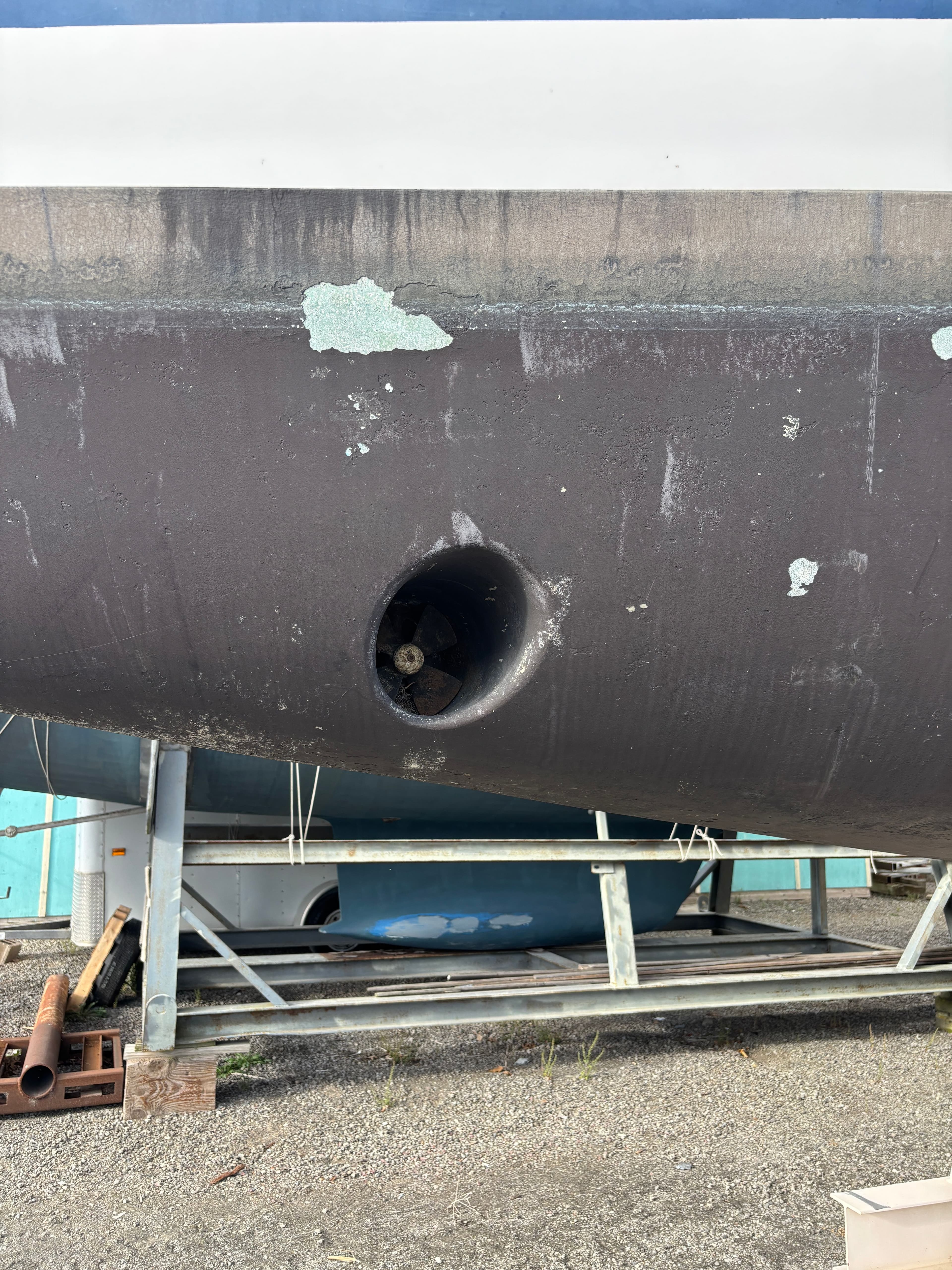 2001 Hunter 460 sailboat hull with visible bow thruster in dry dock.