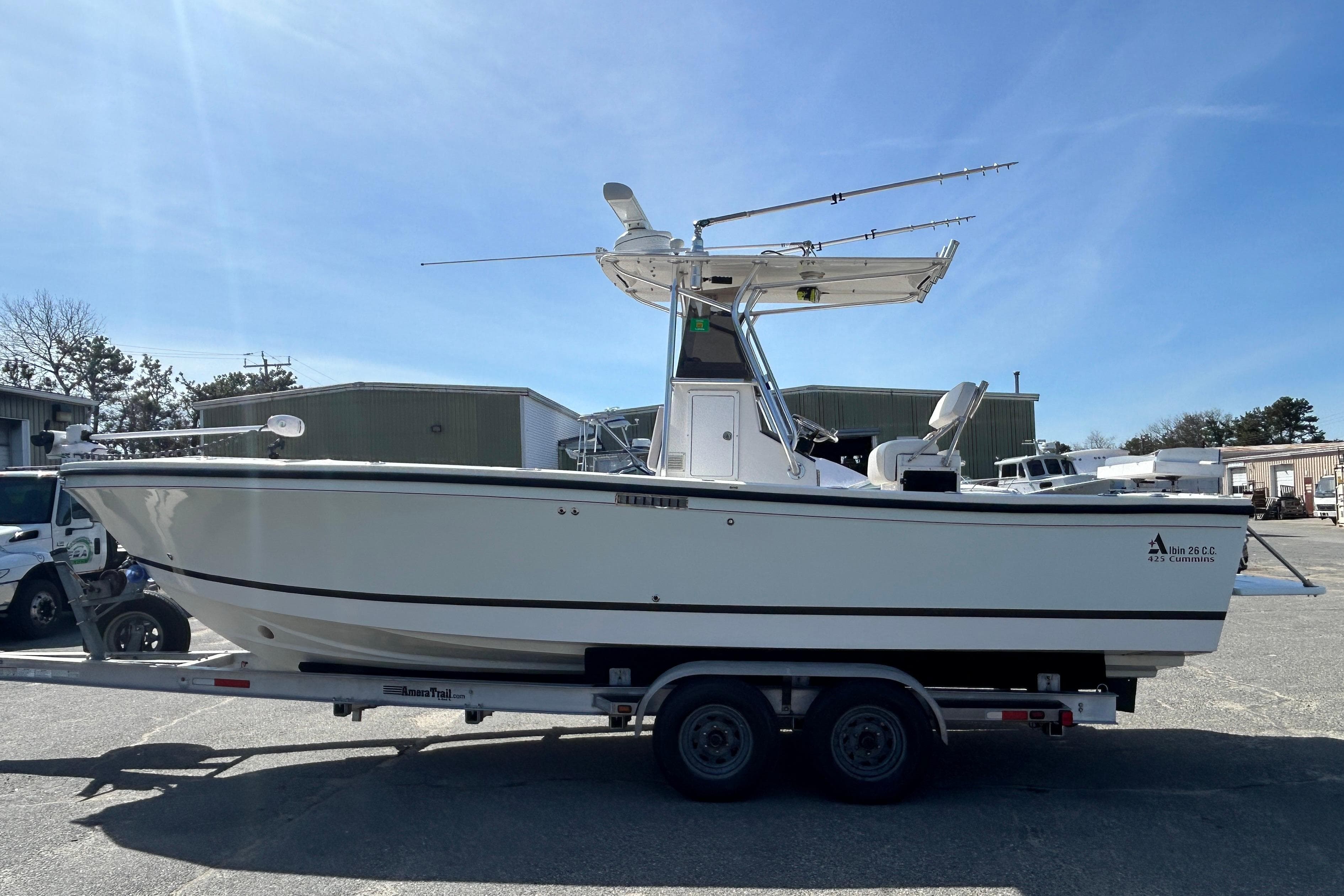 2006 Albin 26 Center Console boat on trailer under clear blue sky.