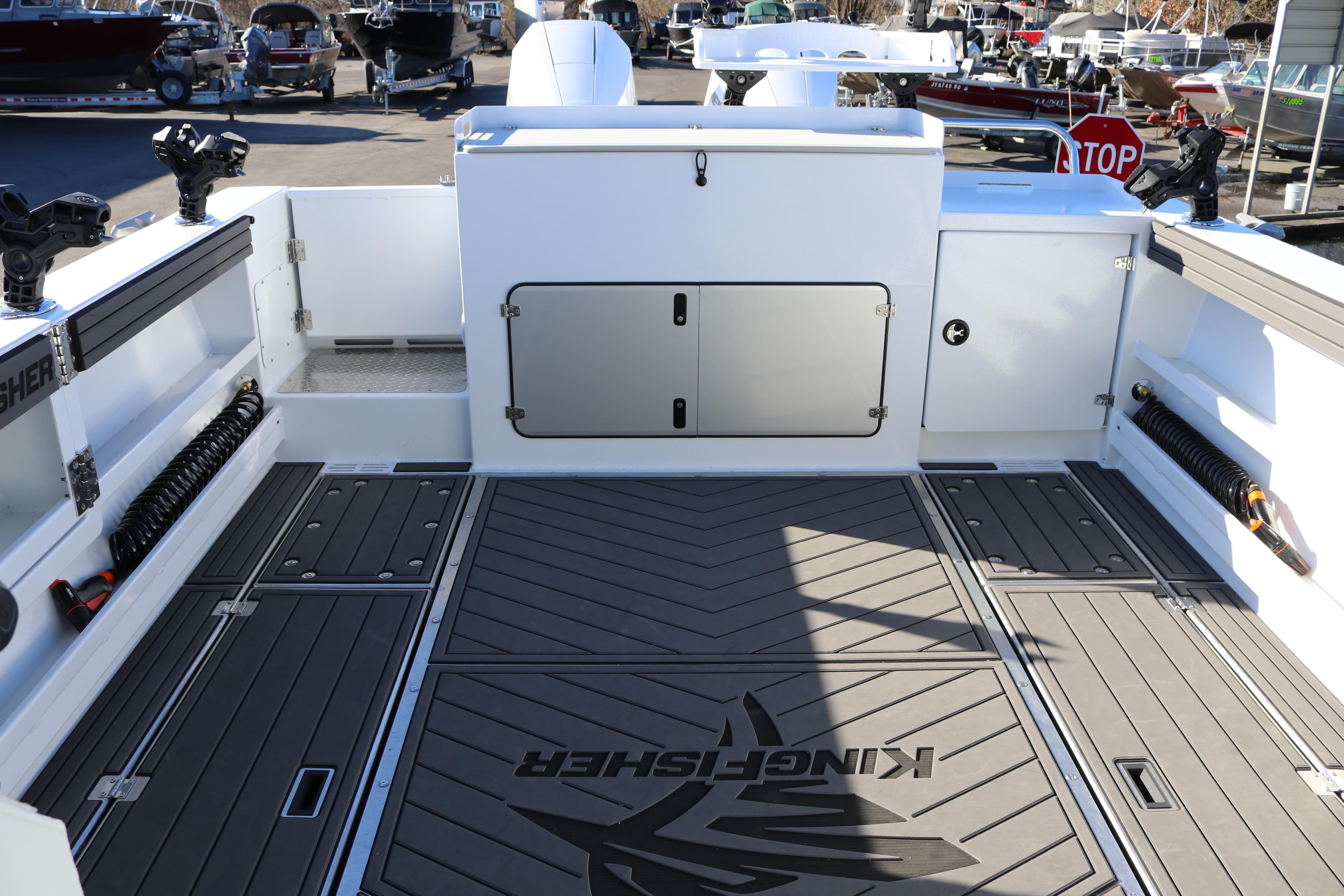 KingFisher 3425 GFX Offshore 2026 boat deck with storage compartments and fishing rod holders.