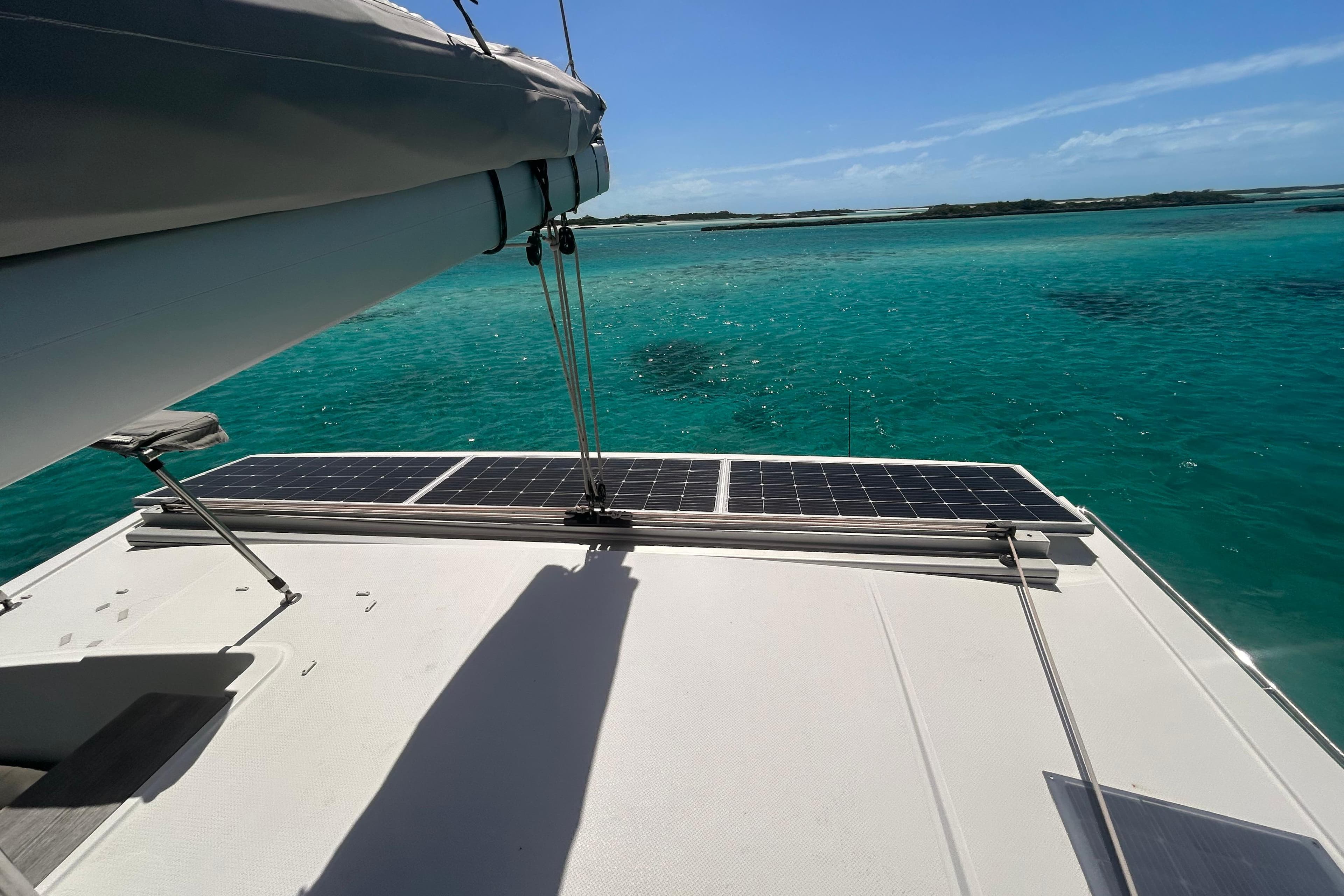 Fountaine Pajot Lucia 40 catamaran with solar panels, sailing on clear turquoise waters.