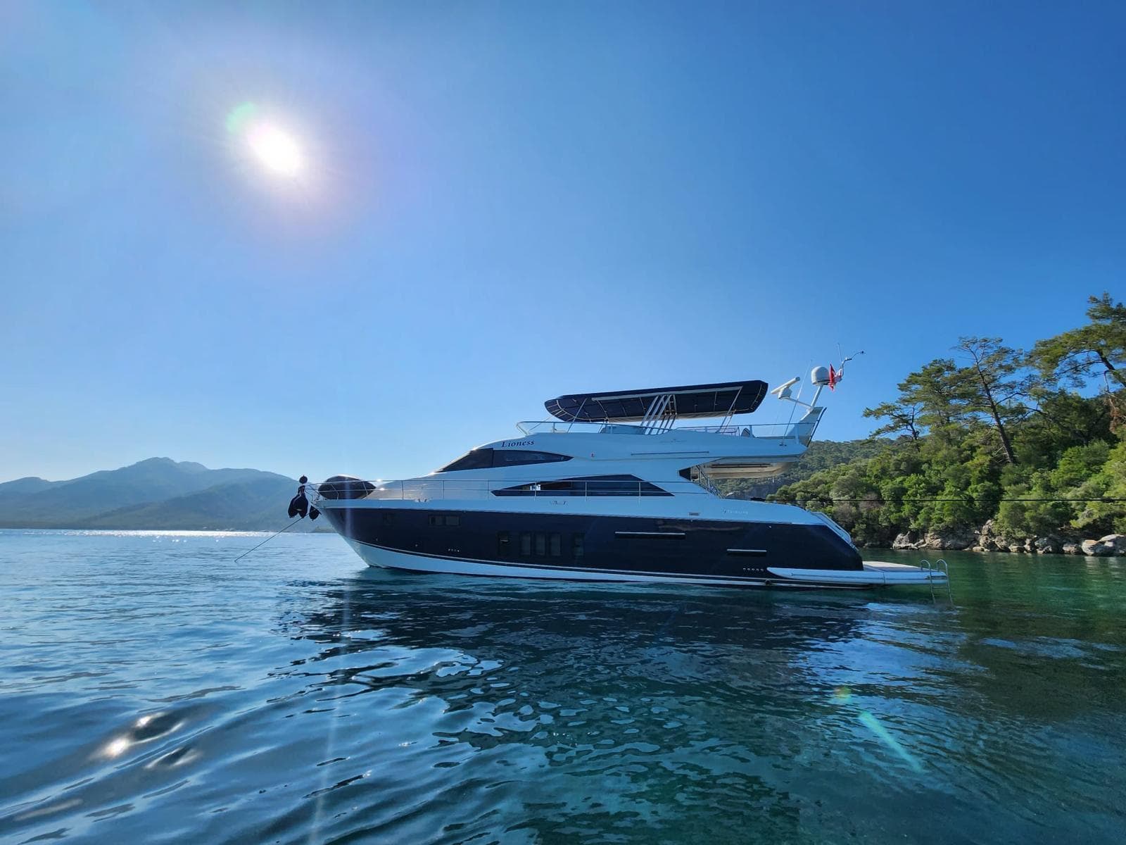Luxury 2012 Fairline Squadron 65 yacht on serene water under clear blue sky.