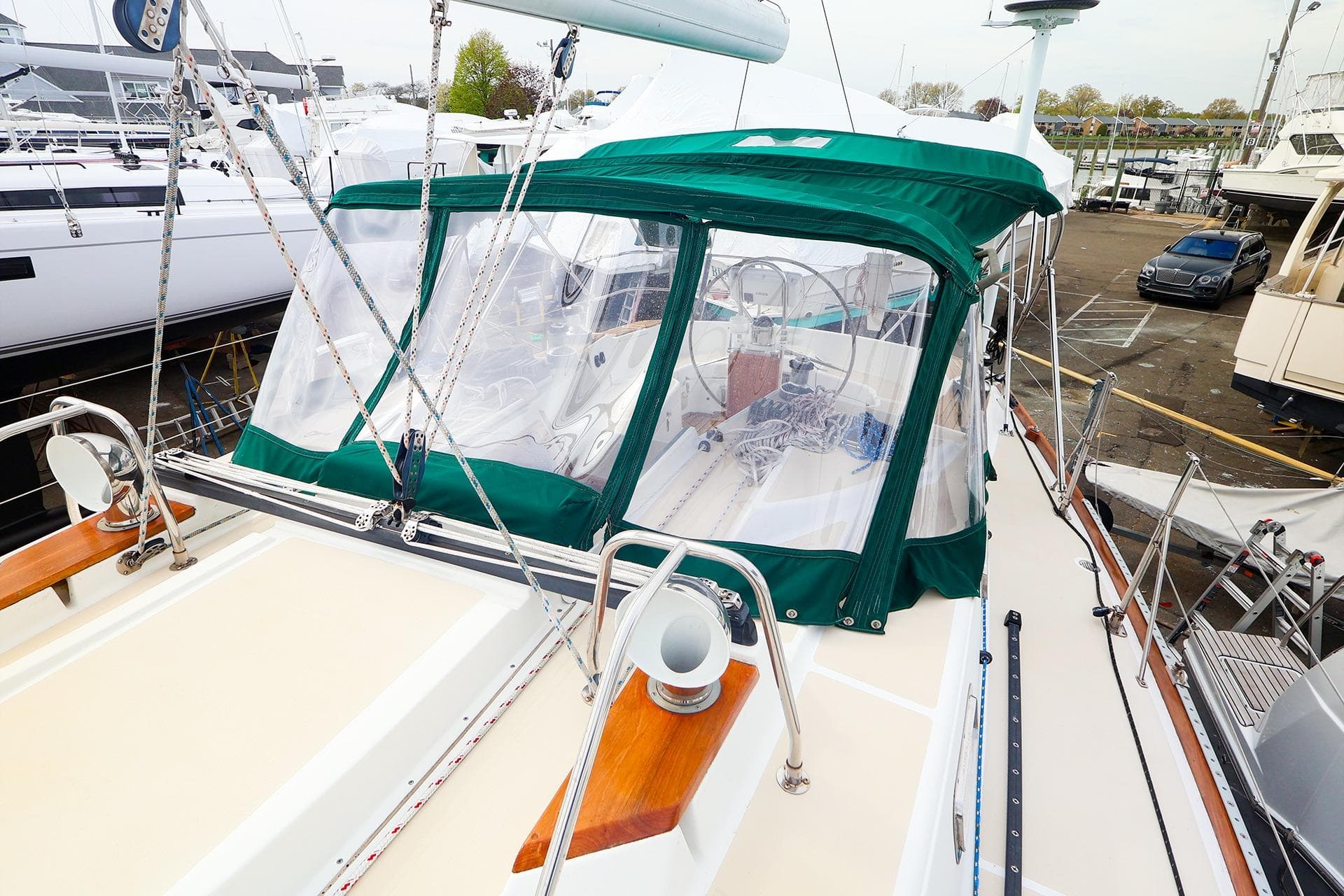 Sailboat Tartan 4100 (2001) with green canopy, docked at marina.
