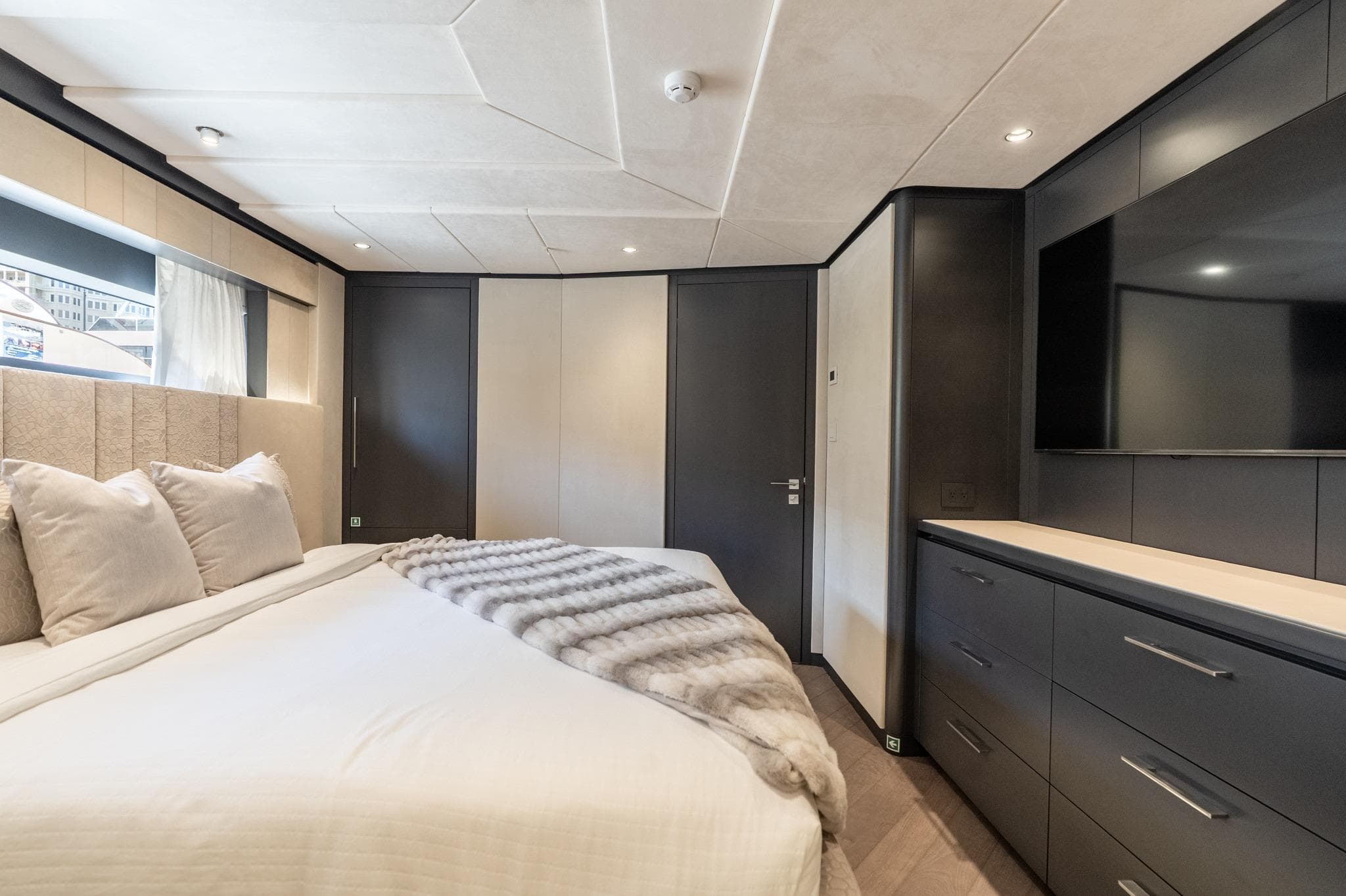Luxurious bedroom interior of 2026 Hargrave E Series yacht, featuring modern design and elegant furnishings.
