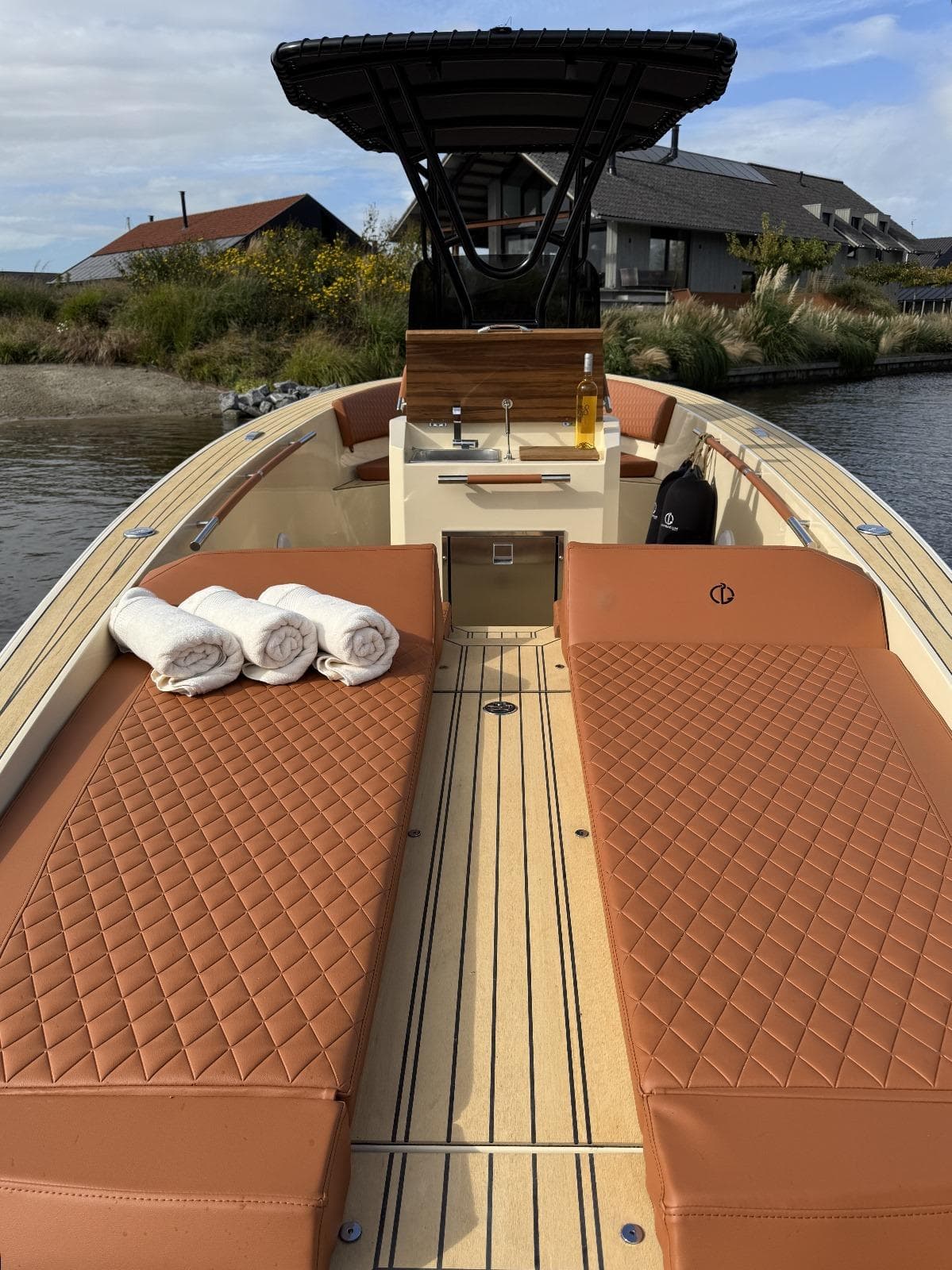 Luxurious AlCustom Levanzo 25 boat, 2025 model, with plush seating and scenic background.