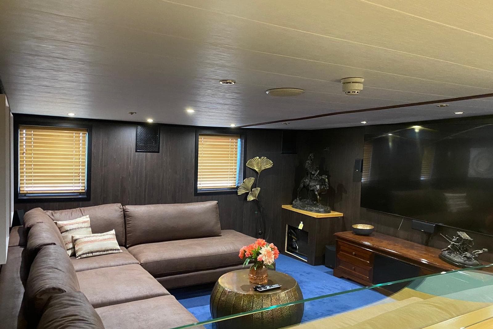 Luxurious yacht interior with plush seating, elegant decor, and large TV, Jadranska Linjska Plovidba, 1954.