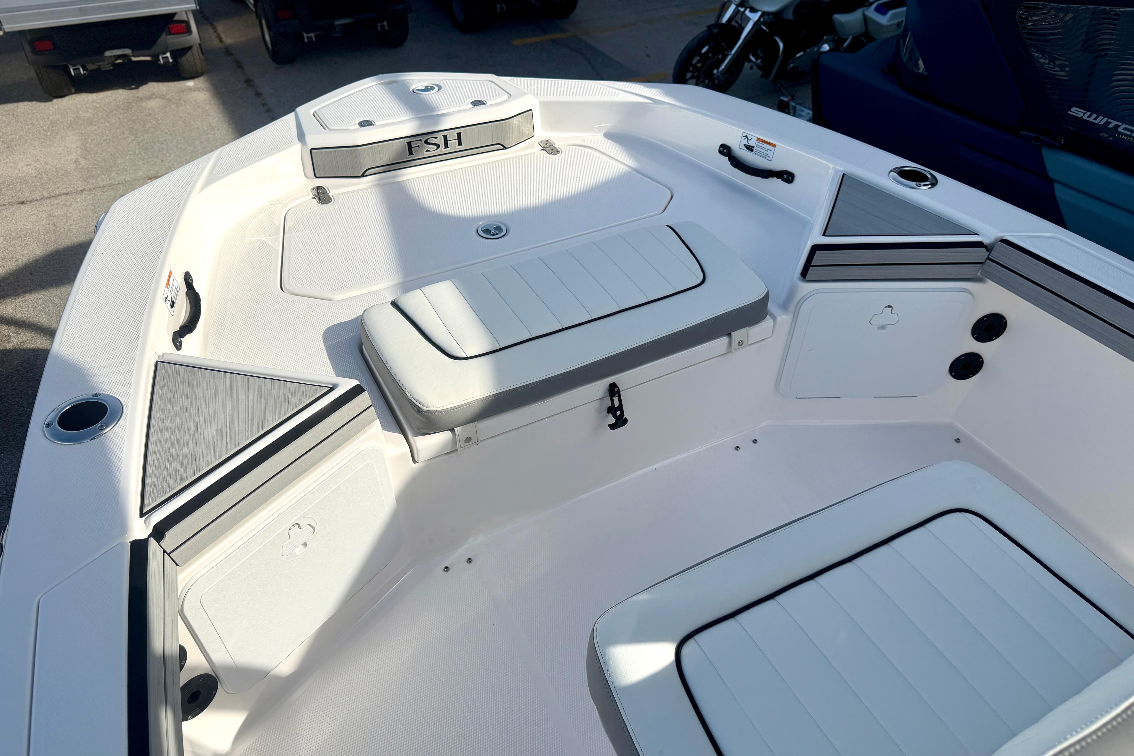 2025 Yamaha Boats 195 FSH Sport interior with seating and storage compartments.