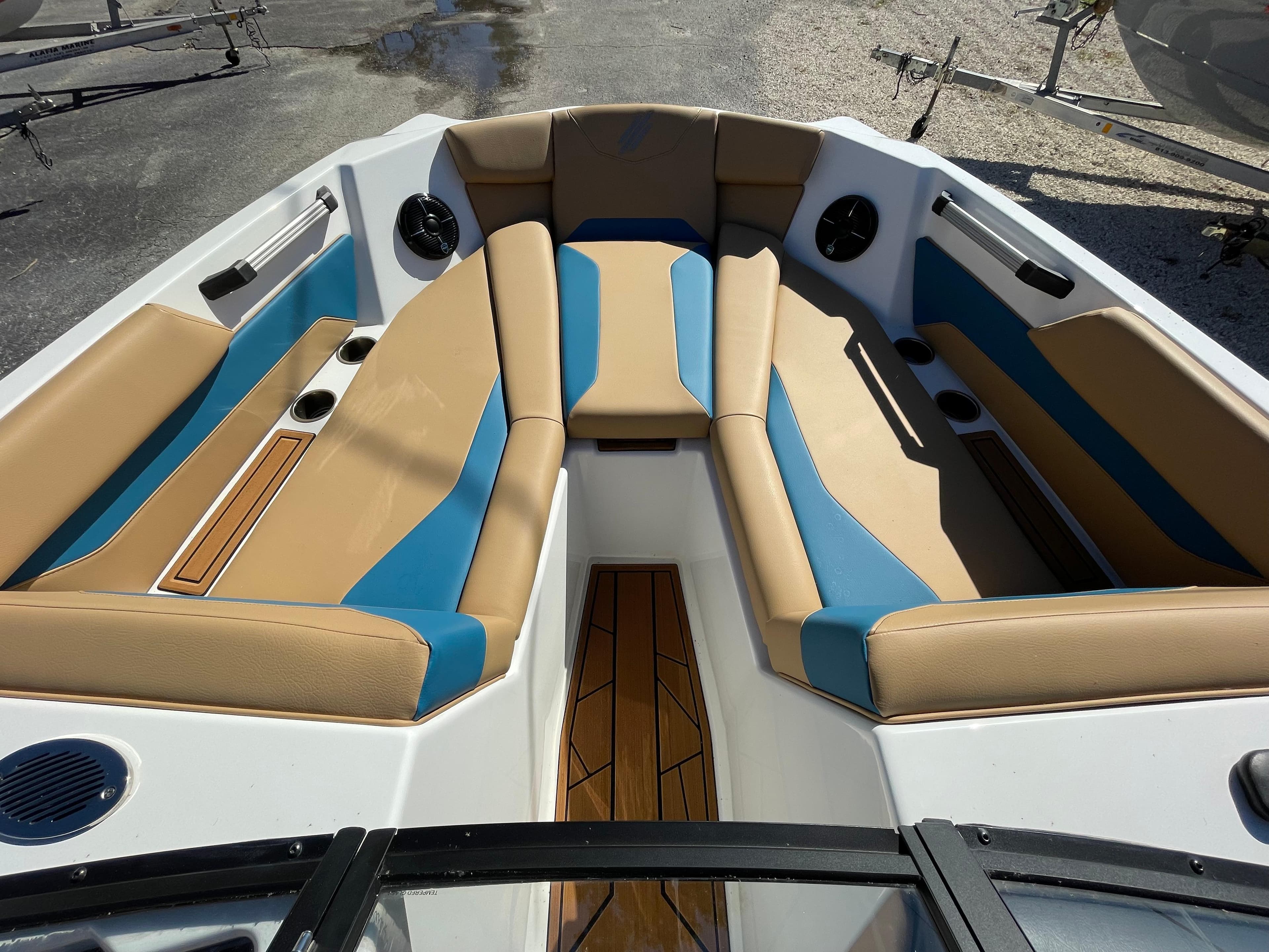 2024 ATX Surf Boats 24 Type-S bow seating area with tan and blue upholstery.