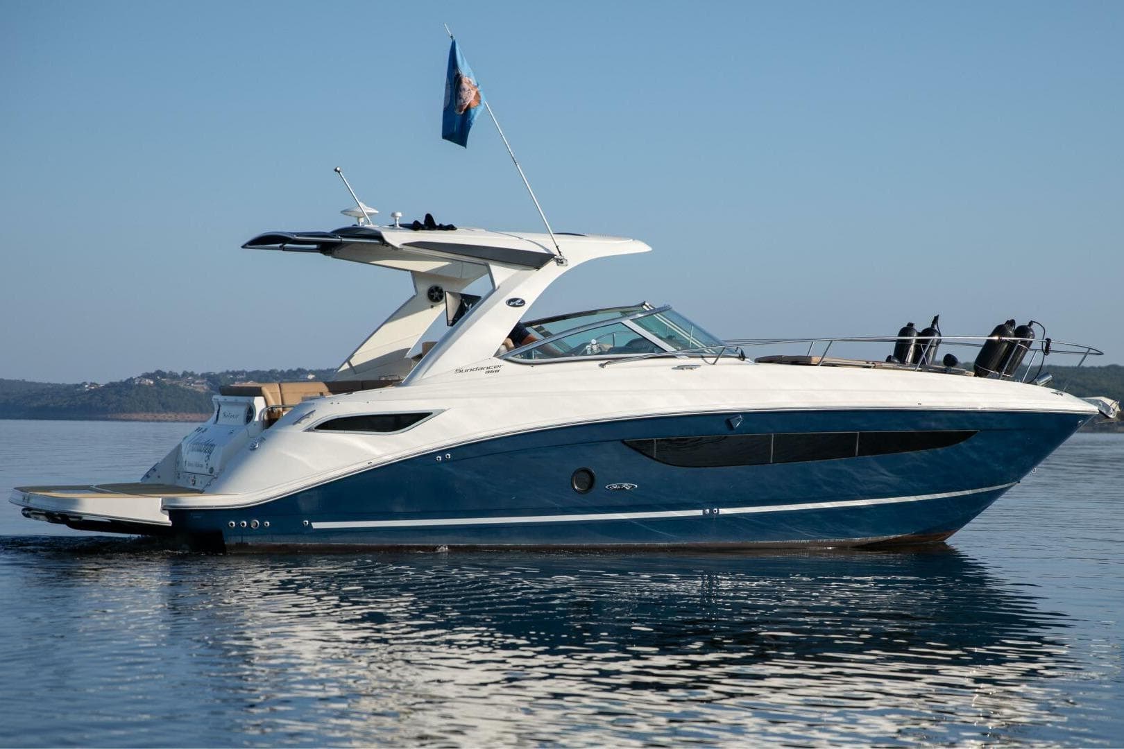 2016 Sea Ray 350 Sundancer yacht on calm water, side view.