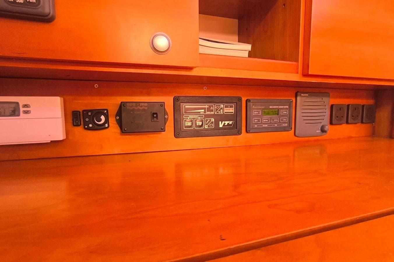 Control panel on 2007 Hanse 470e yacht with various electronic devices and switches.
