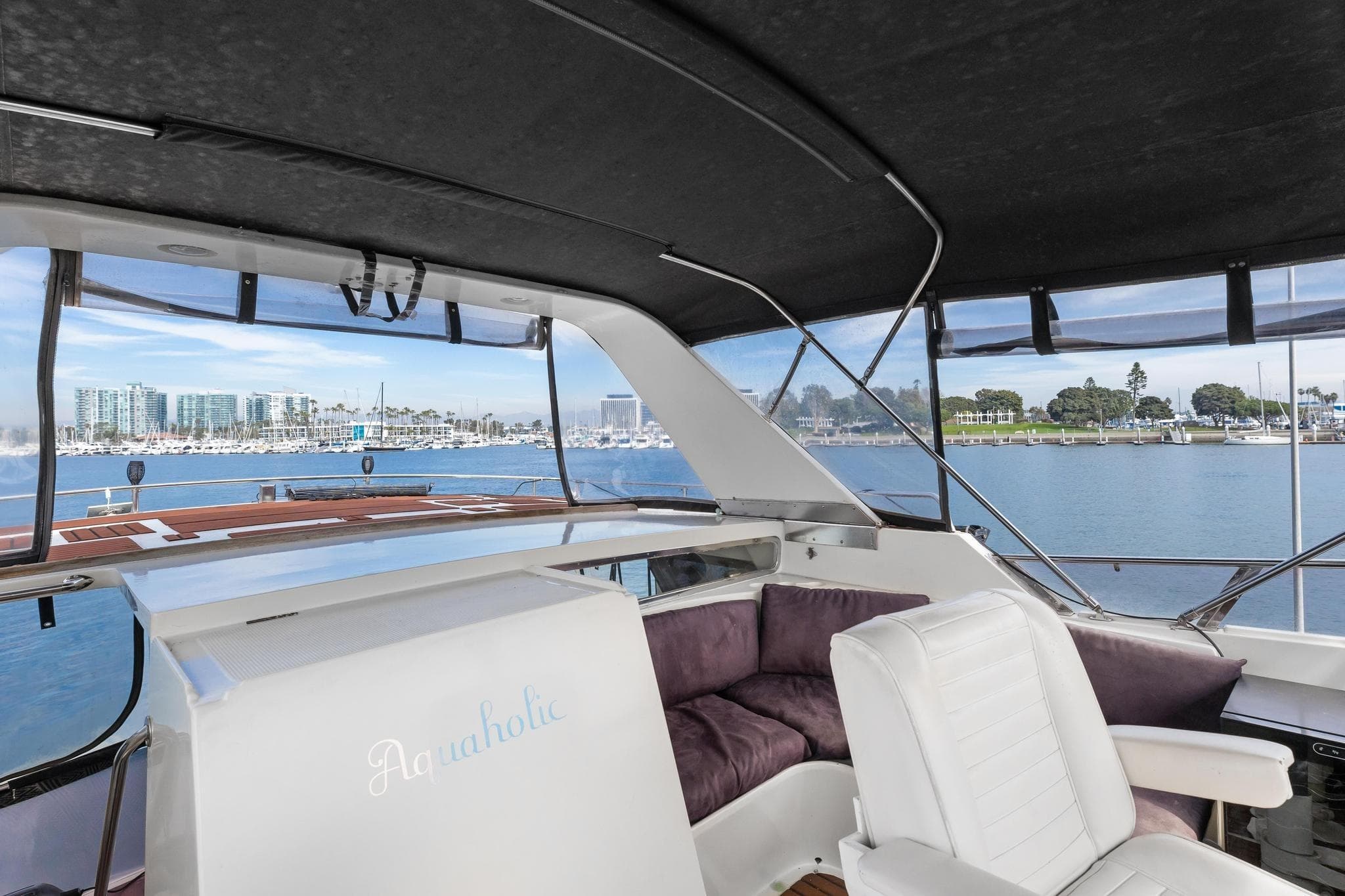 1988 Marine Trader Trawler interior with seating, overlooking marina and waterfront views.