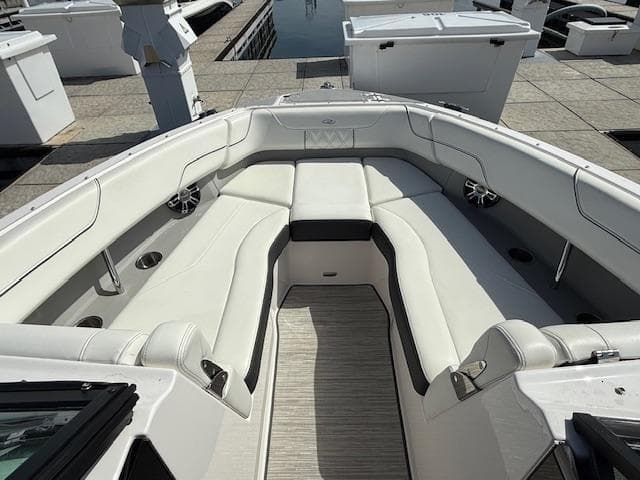 2020 Regal LS6 Surf boat interior with white seating and cup holders.
