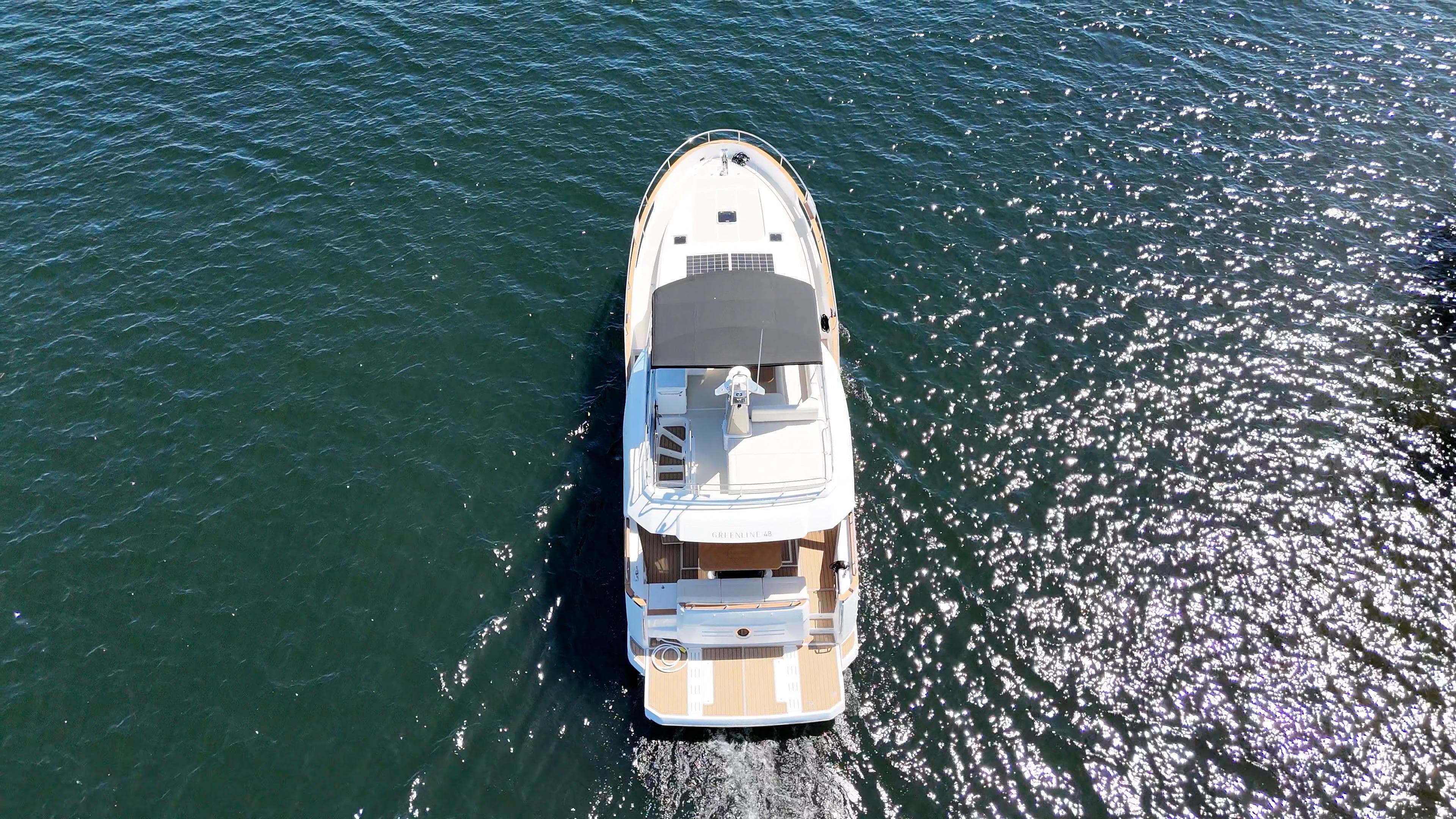 Aerial view of 2024 Greenline 48 Fly yacht cruising on open water.