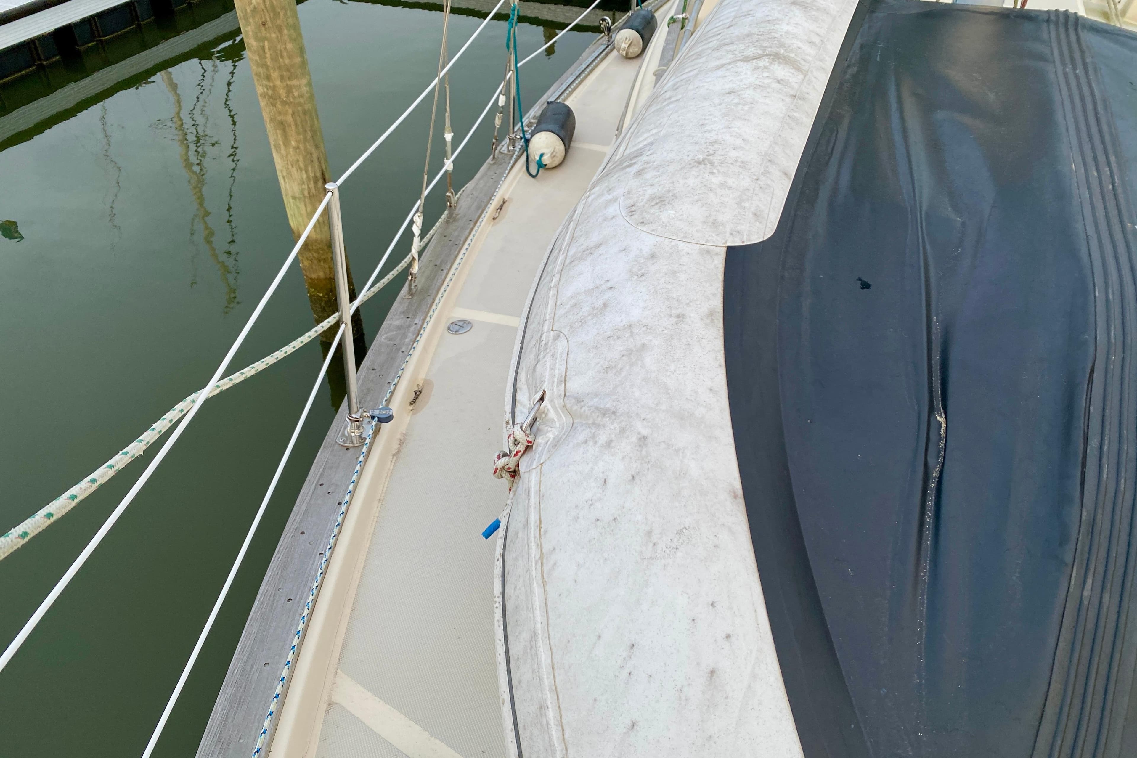 1992 Island Packet 29 sailboat deck with railing and docked fender.
