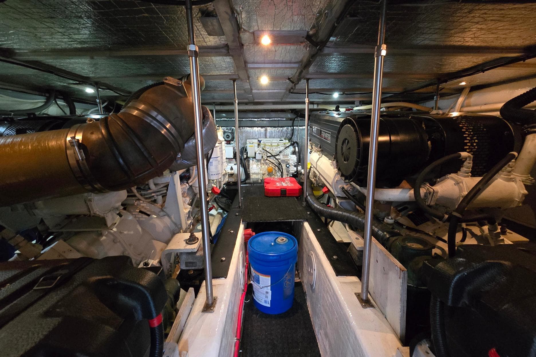 Engine room of 2001 Carver 570 Voyager Pilothouse with visible machinery and equipment.