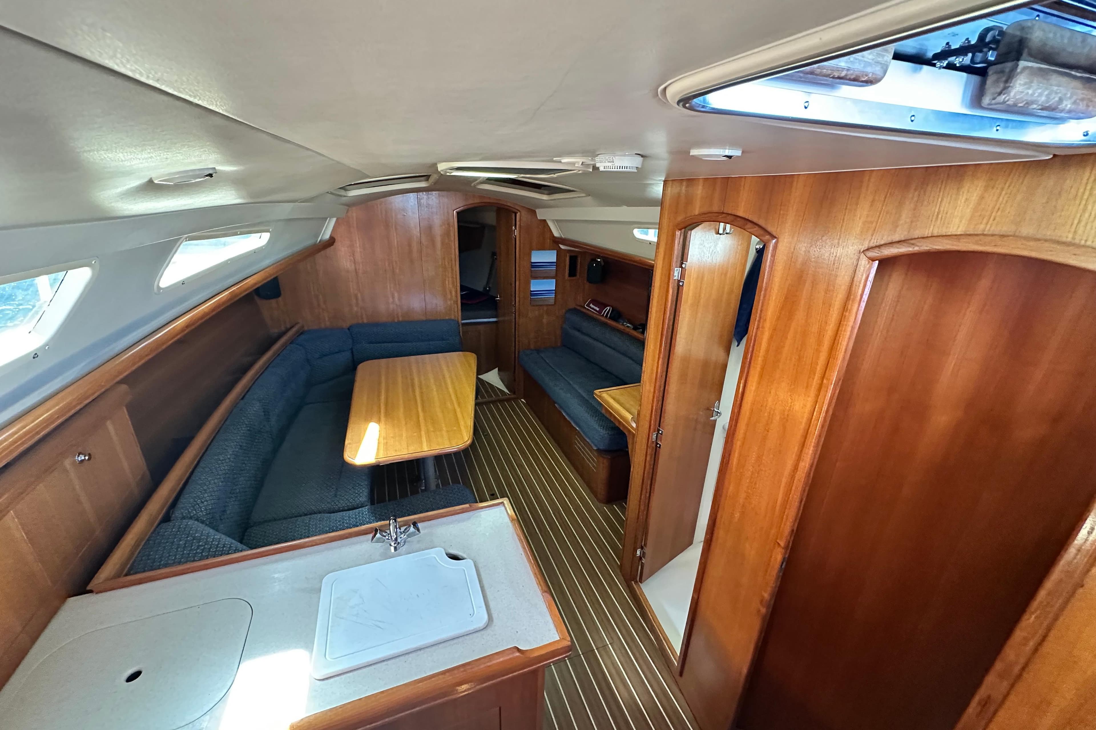 Interior of 2008 Hunter 33 sailboat with wood finish and seating area.