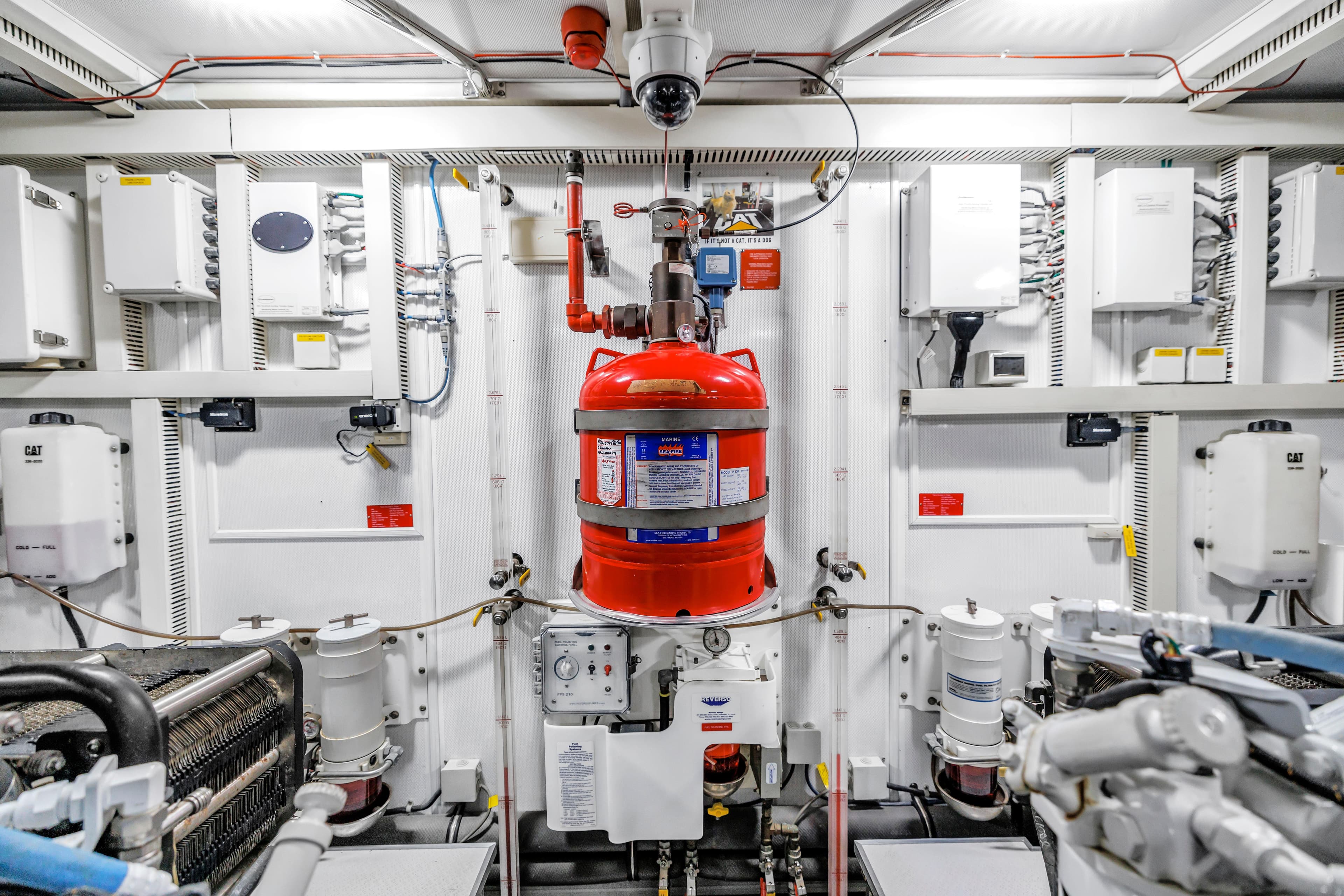 Engine room of 2015 Horizon E88 yacht with fire suppression system and control panels.
