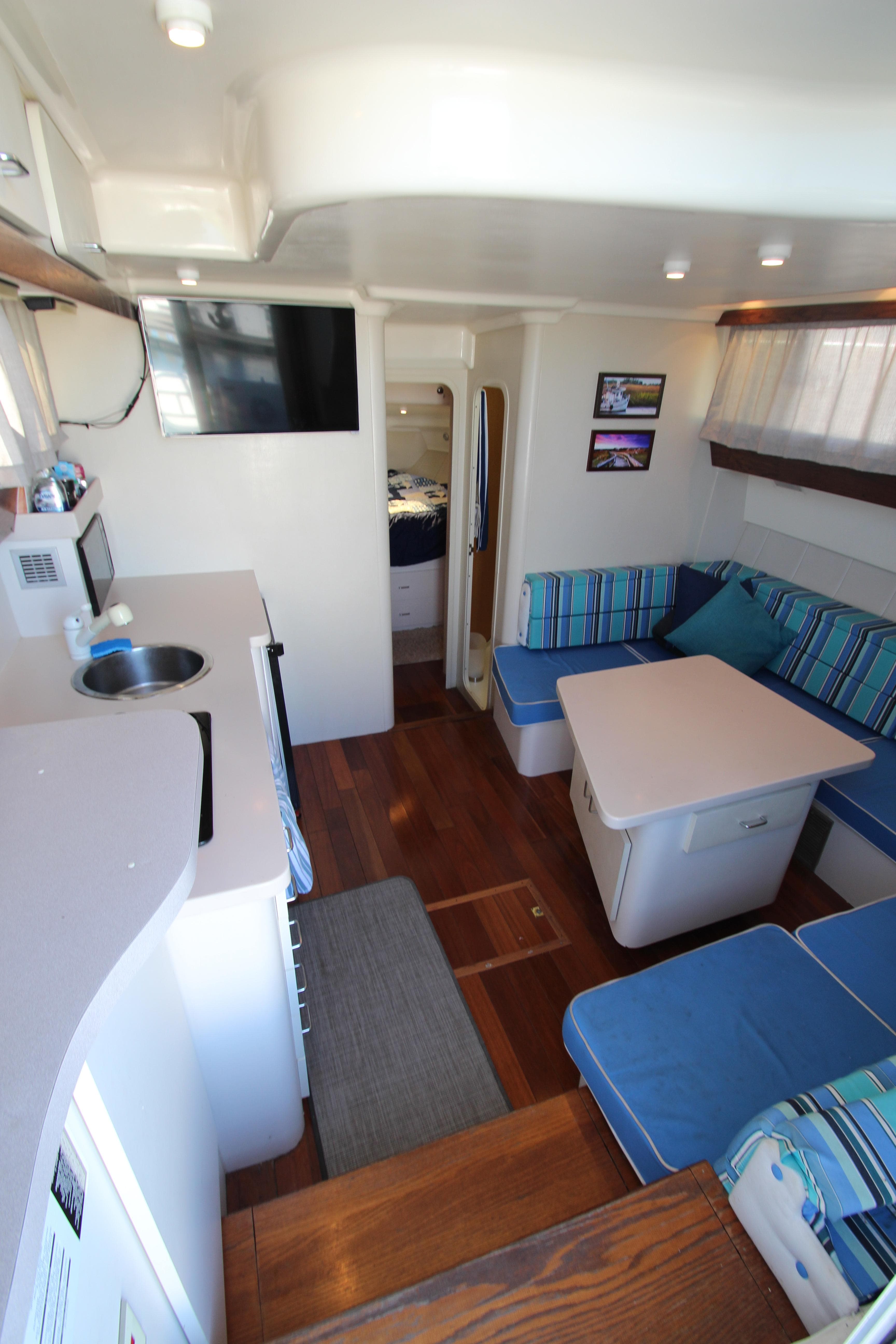 1995 Mainship 31 Sedan Bridge interior with cozy seating and modern amenities.