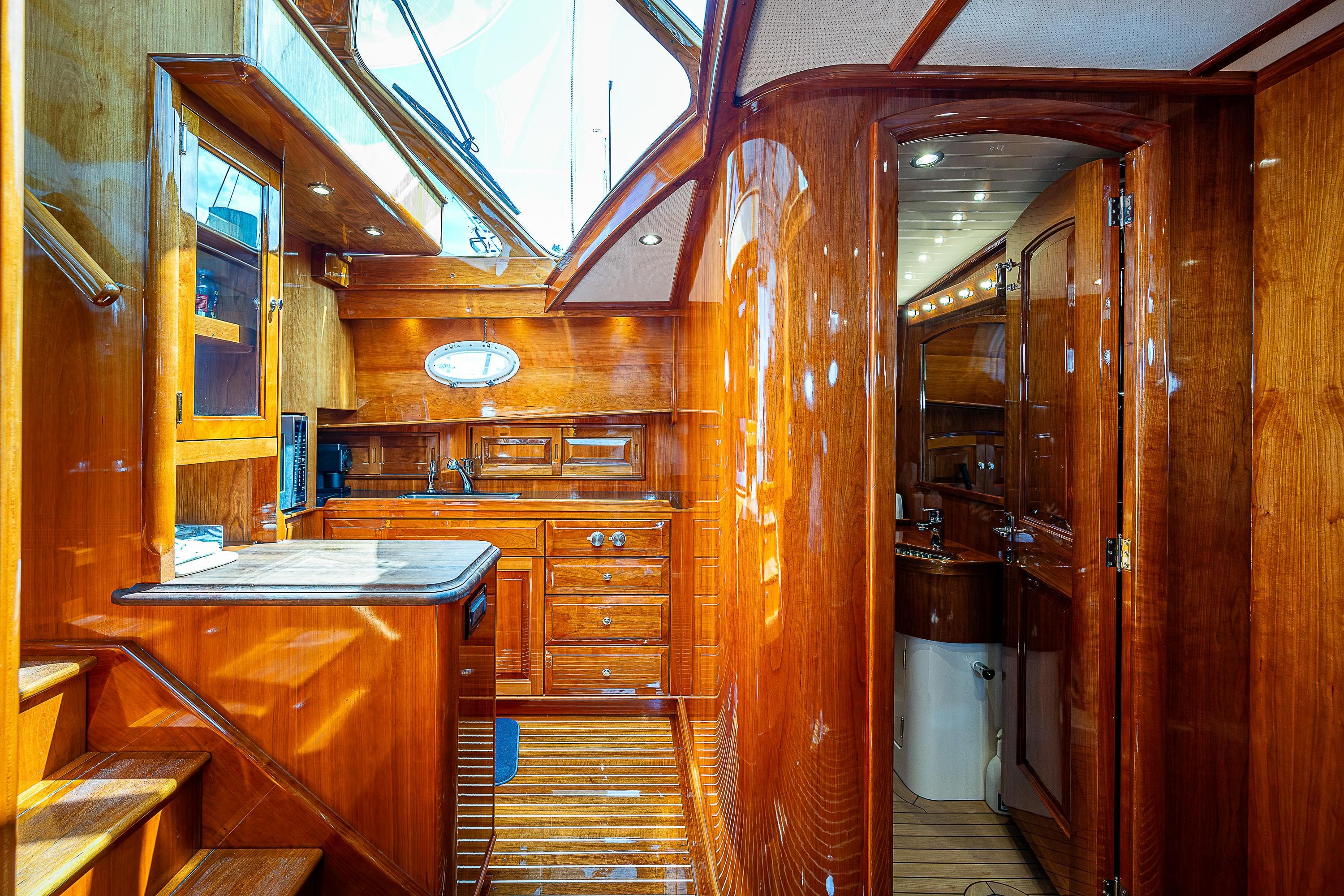 Luxurious 2018 Hinckley Talaria 55 MKII MY yacht interior with polished wood finish.