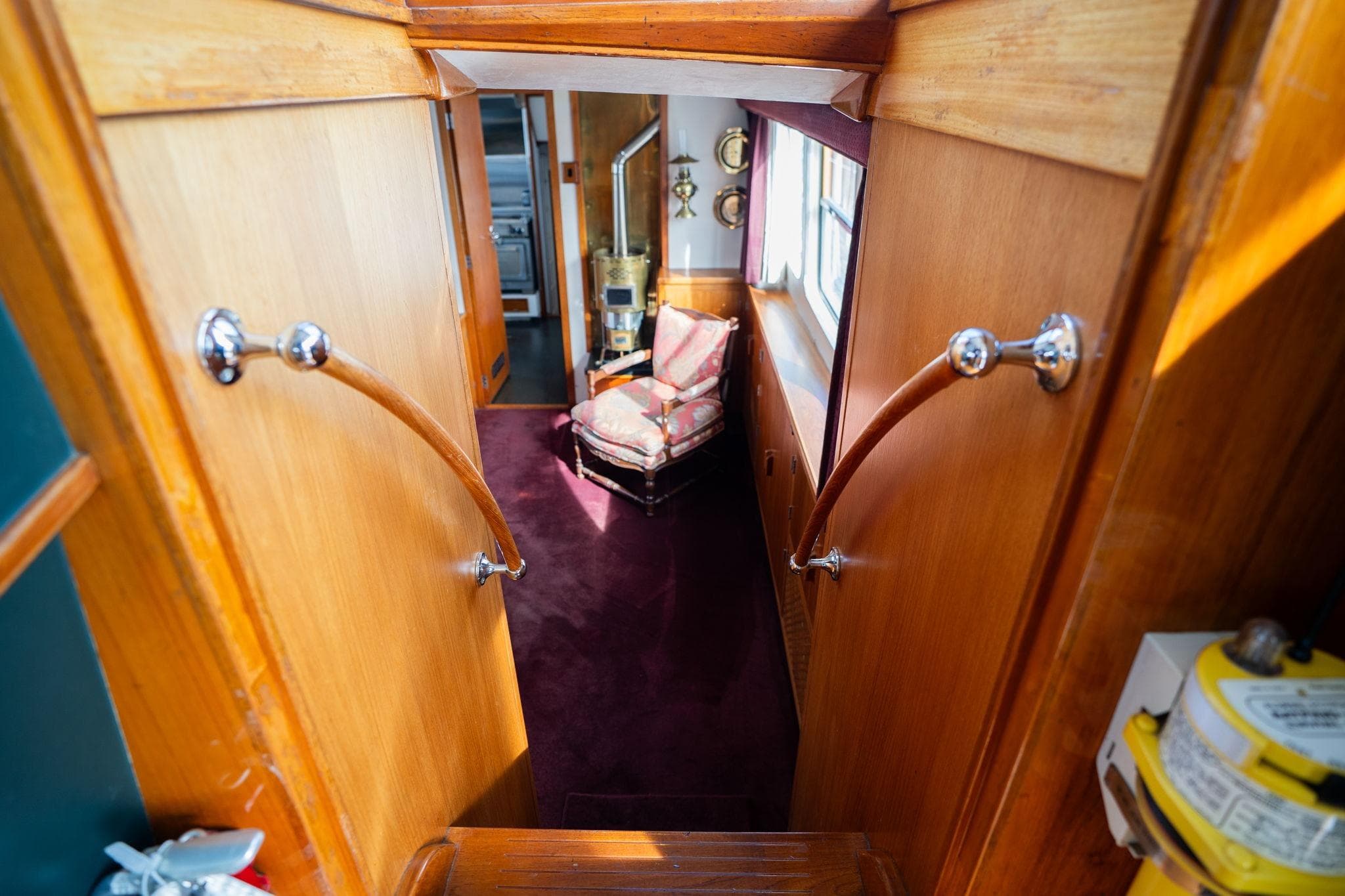 Interior of 1965 De Vries Lentsch 64 Motoryacht with wooden paneling and vintage decor.