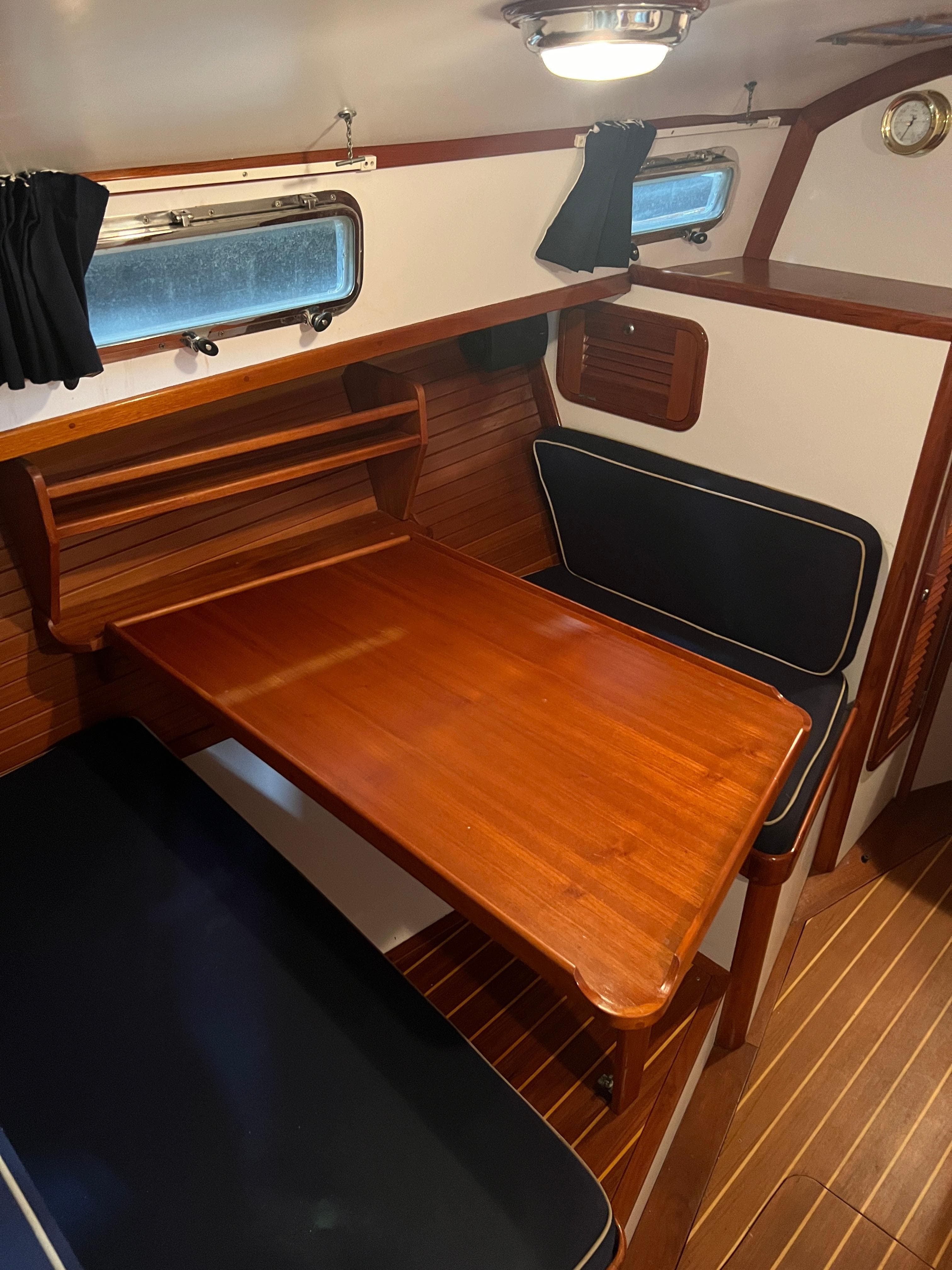 Interior of 2000 Bruckmann Bluestar 29.9 with wooden table and seating.