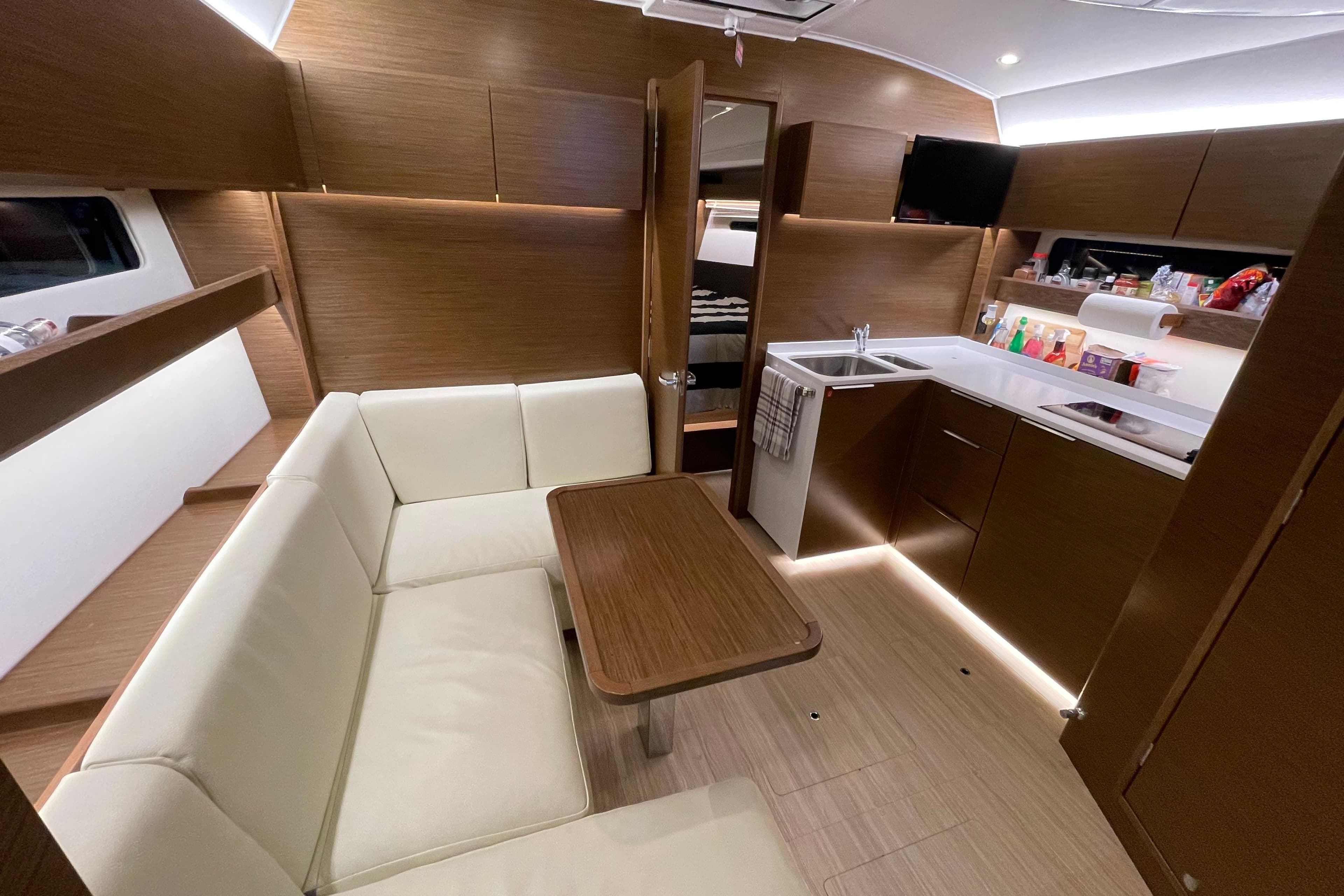 Luxurious interior of 2020 Bavaria S40 Coupe yacht with modern kitchen and seating area.