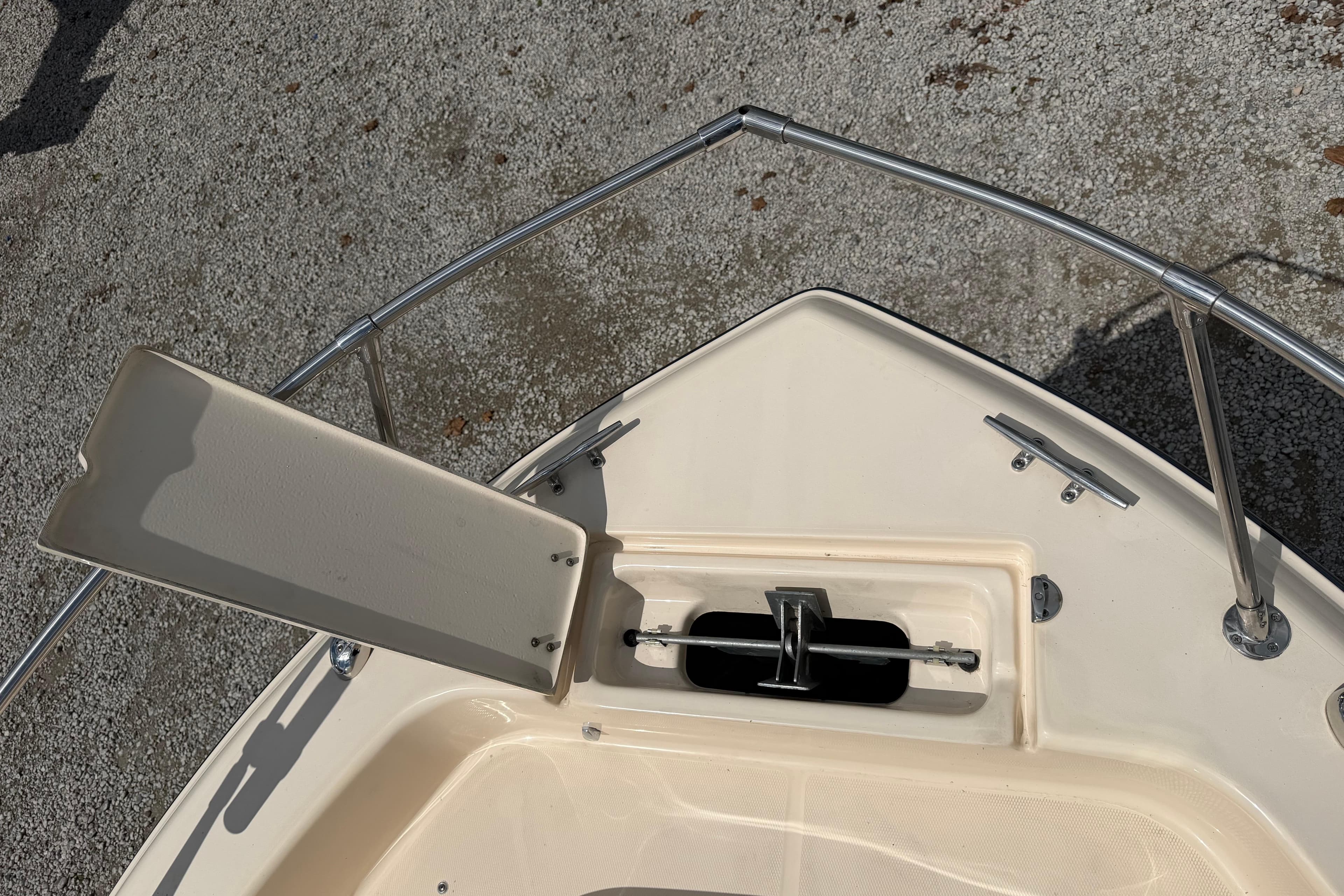 Bow of 2011 Grady-White Adventure 208 boat with open anchor compartment.