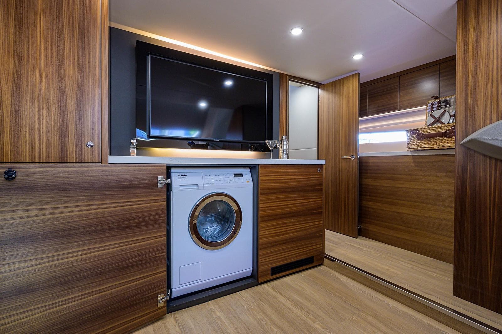 Interior of Maritimo X60 yacht with washing machine and TV, 2020 model.