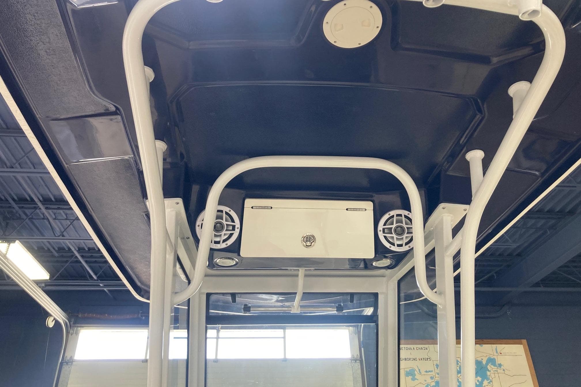 2024 Robalo R250 Center Console boat interior with speakers and storage compartment.