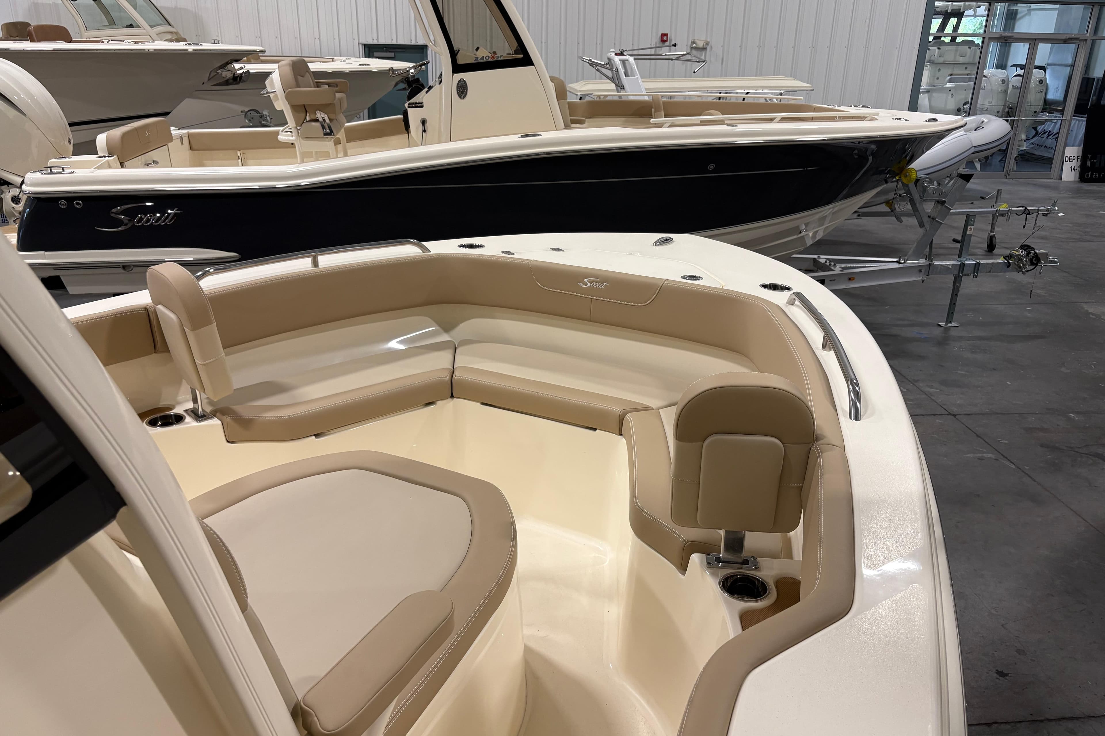 2025 Scout 215 XSF boat interior with beige seating in showroom.