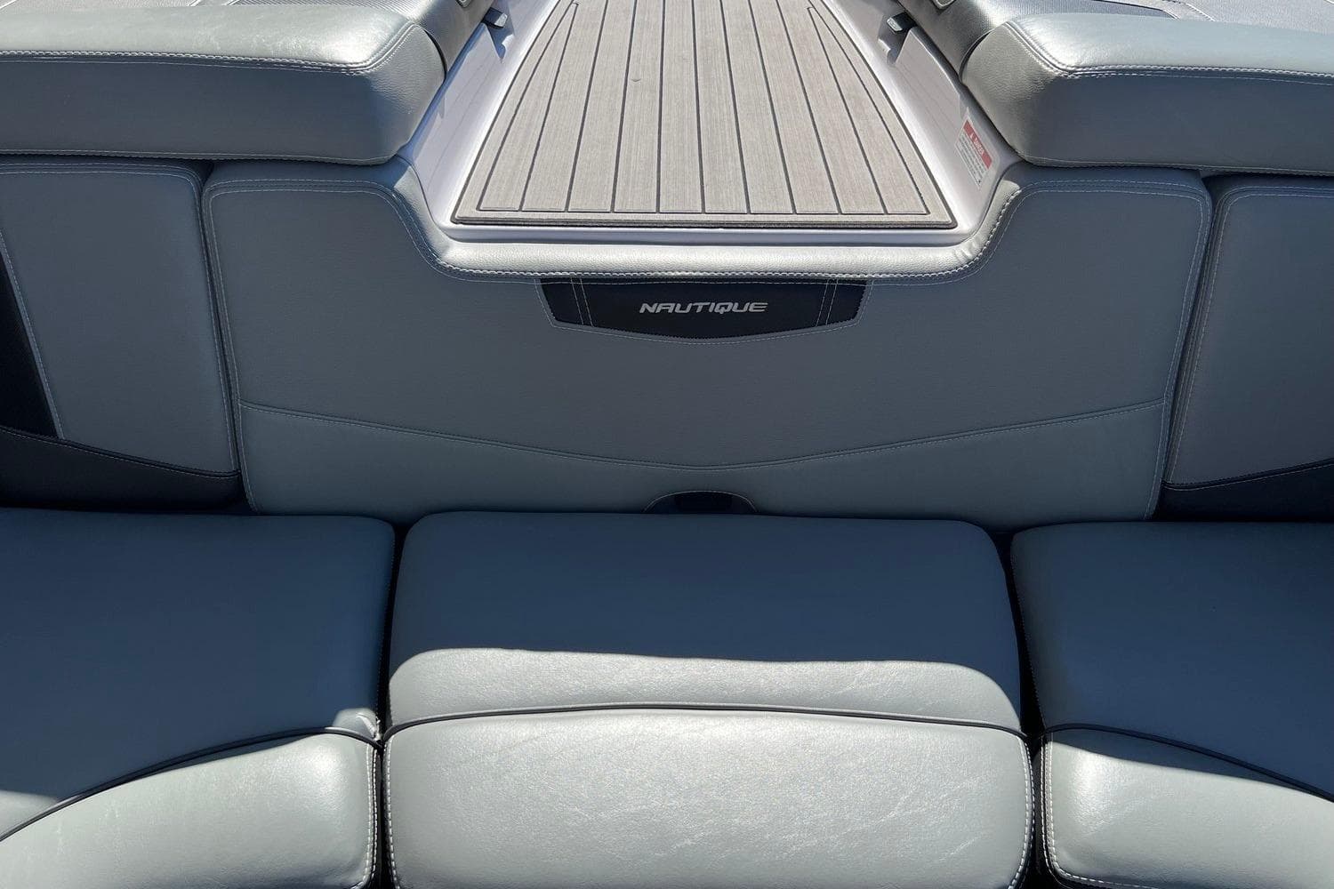 2014 Nautique Super Air Nautique 210 boat interior with gray seating and deck.