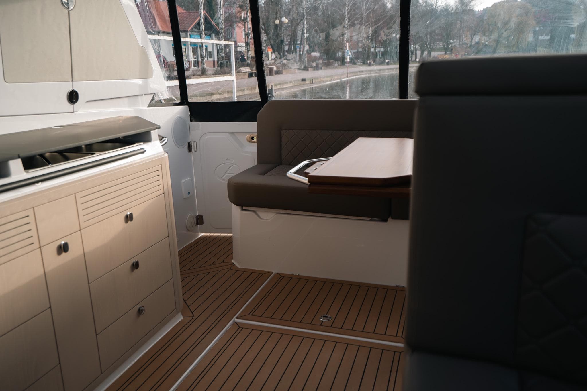 Interior of 2026 Aquador 400HT boat with modern seating and cabinetry.