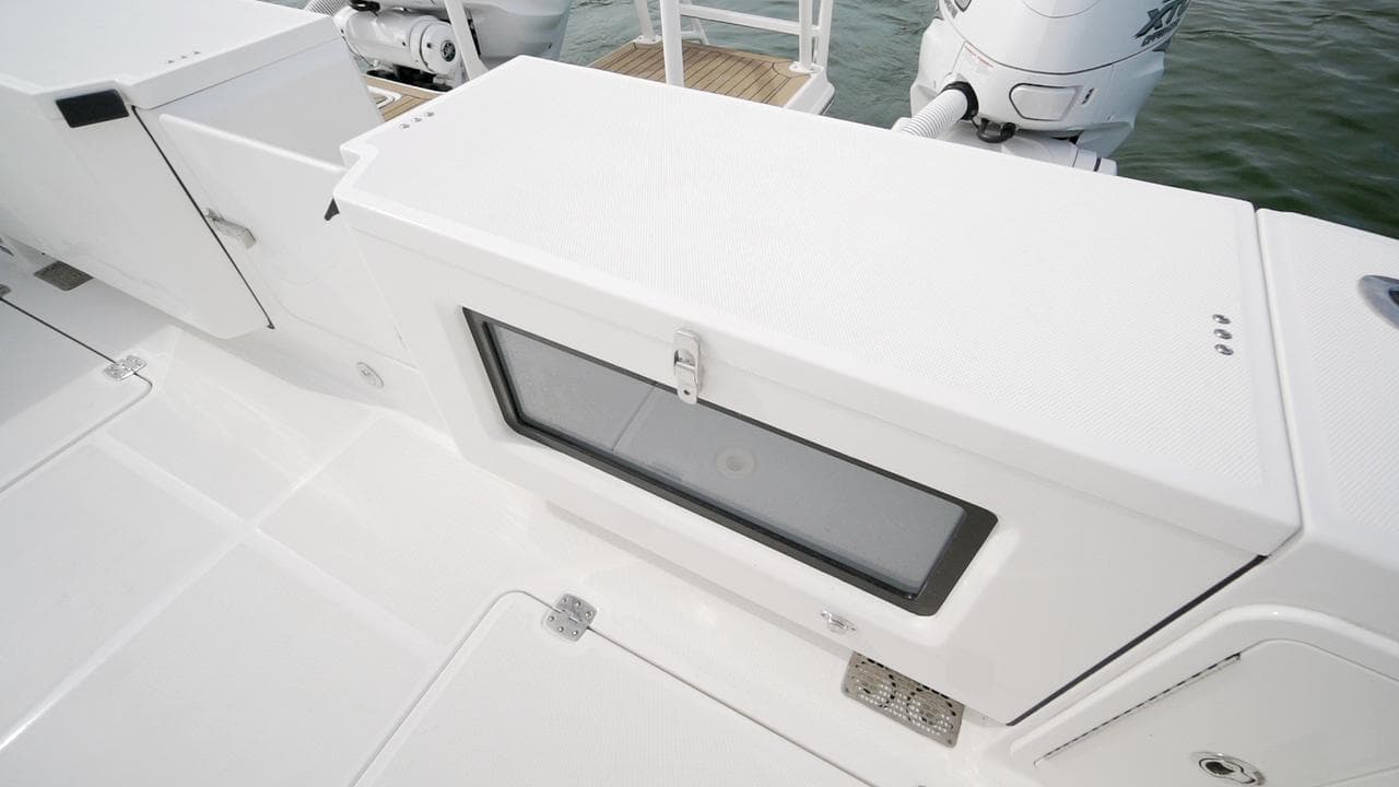 2026 World Cat 400CC-X boat deck with storage compartment and outboard motors.